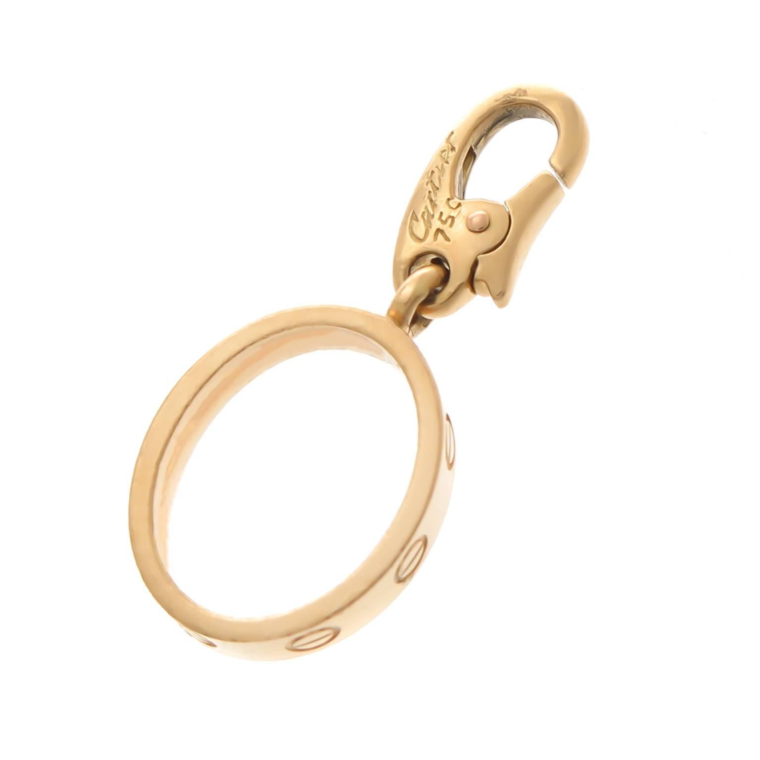 Cartier 18K Yellow Gold Love Ring Charm measuring 1/2 inch X 3/8 inch, can be easily attached to a bracelet or worn as a pendant. Signed and Numbered with French Hall Marks. Circa 2000