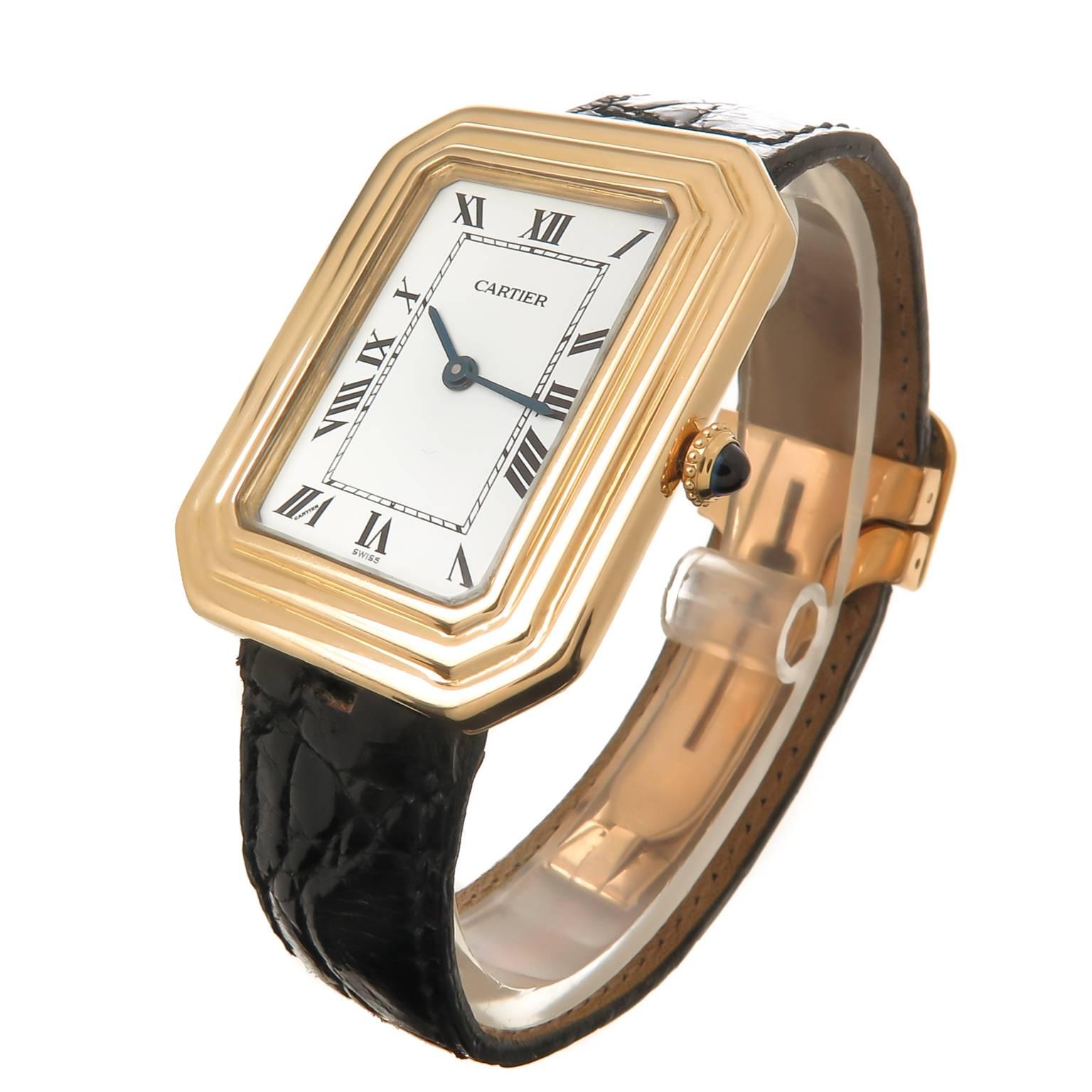 Circa 1970s Cartier Cristallor 18K Yellow Gold Wrist watch, 34 X 27 MM 2 piece water resistant stepped case. This is the Large Model of the Cristallor collection. 17 Jewel Manual wind Cartier movement. White Dial with Black Roman Numerals and a
