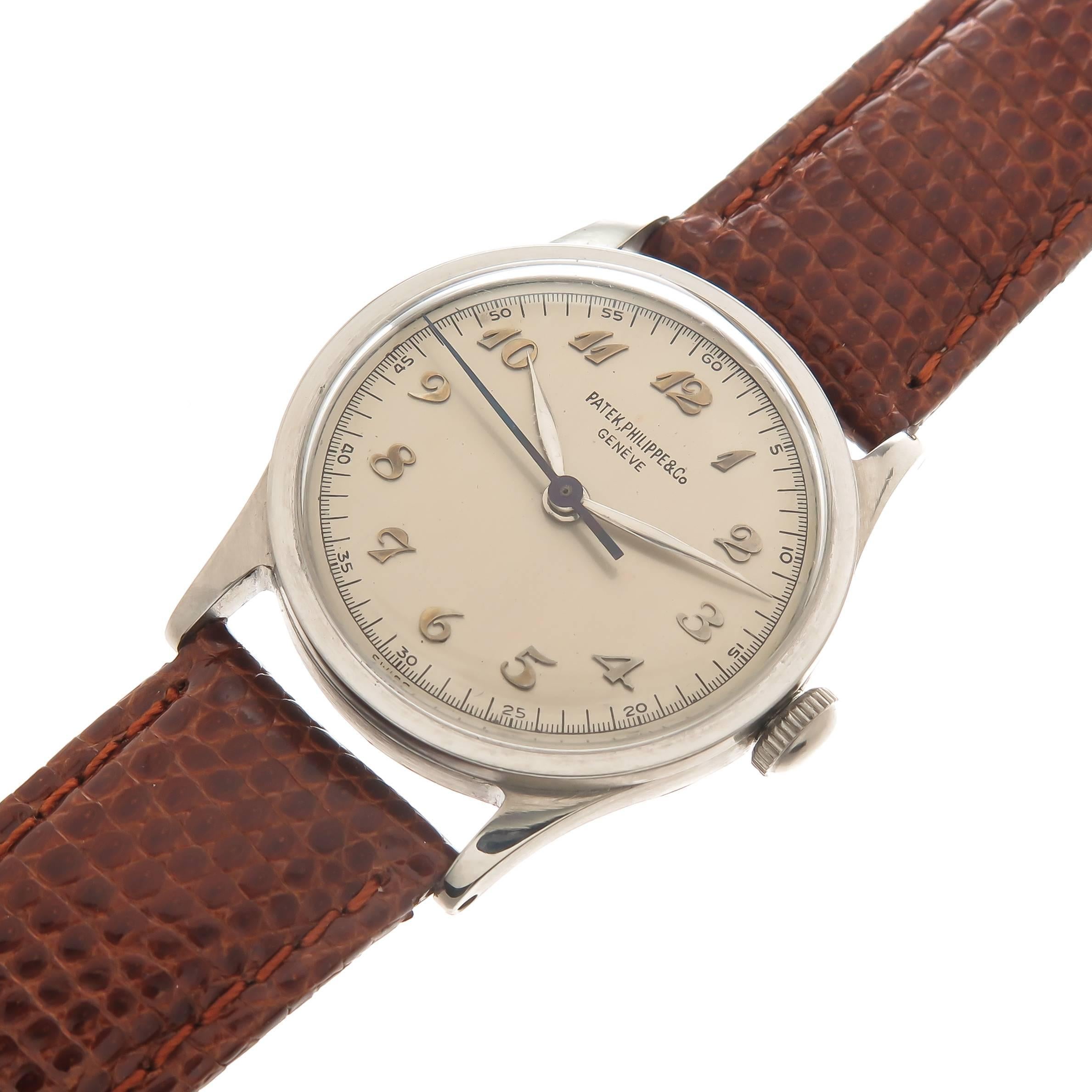 Circa 1940s Patek Philippe Reference 96 Calatrava In a 30 MM 3 piece Stainless Steel Case. Manual wind 20 Jewel Movement. Original, mint Silvered Dial with Raised Gold Breguet Numbers and a sweep seconds hand. Triple signed, with all correct case