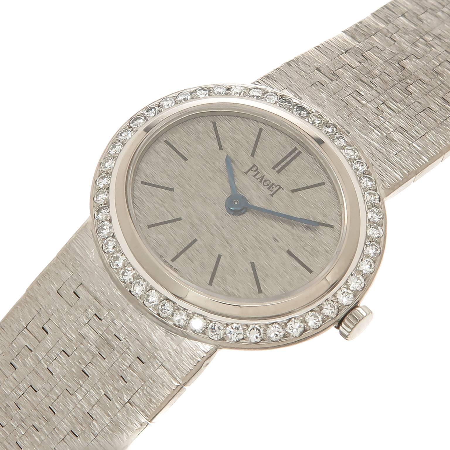 Circa 1970 Piaget Ladies Wrist watch, 18K White gold with a Diamond set bezel of fine white round Brilliant cuts totaling 1 Carat. The case measures 1 1/16 X 7/8 inch and is attached to a soft textured mesh Piaget signed bracelet, total length 6 1/2