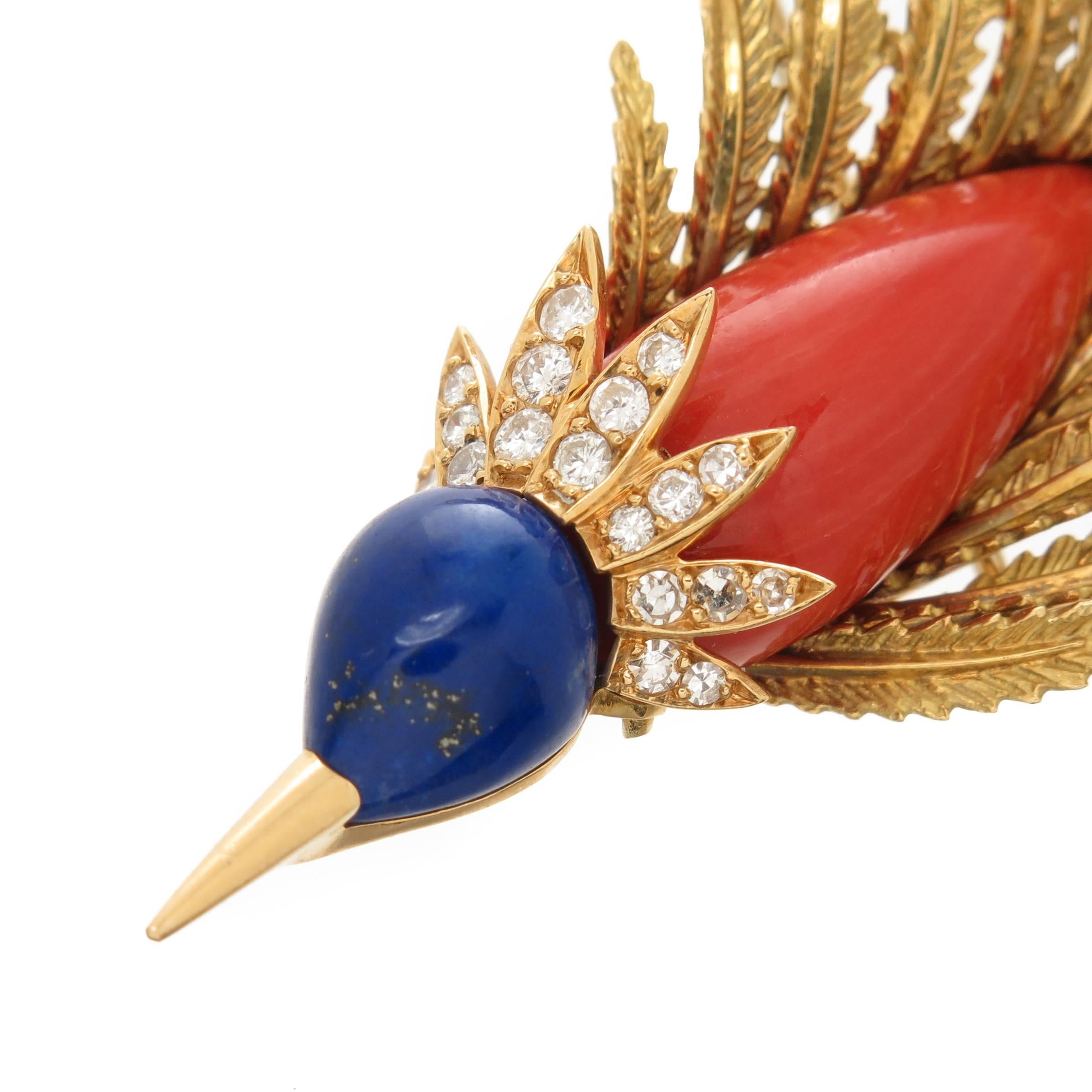 Circa 1960s Cartier Paris 18K yellow Gold Bird Clip Brooch. Measuring 3 3/4 inch in length. Centrally set with a fine color Coral for the Body, Lapis Lazuli for the Head and further set with numerous Diamonds.Hand made with nice texturing work for
