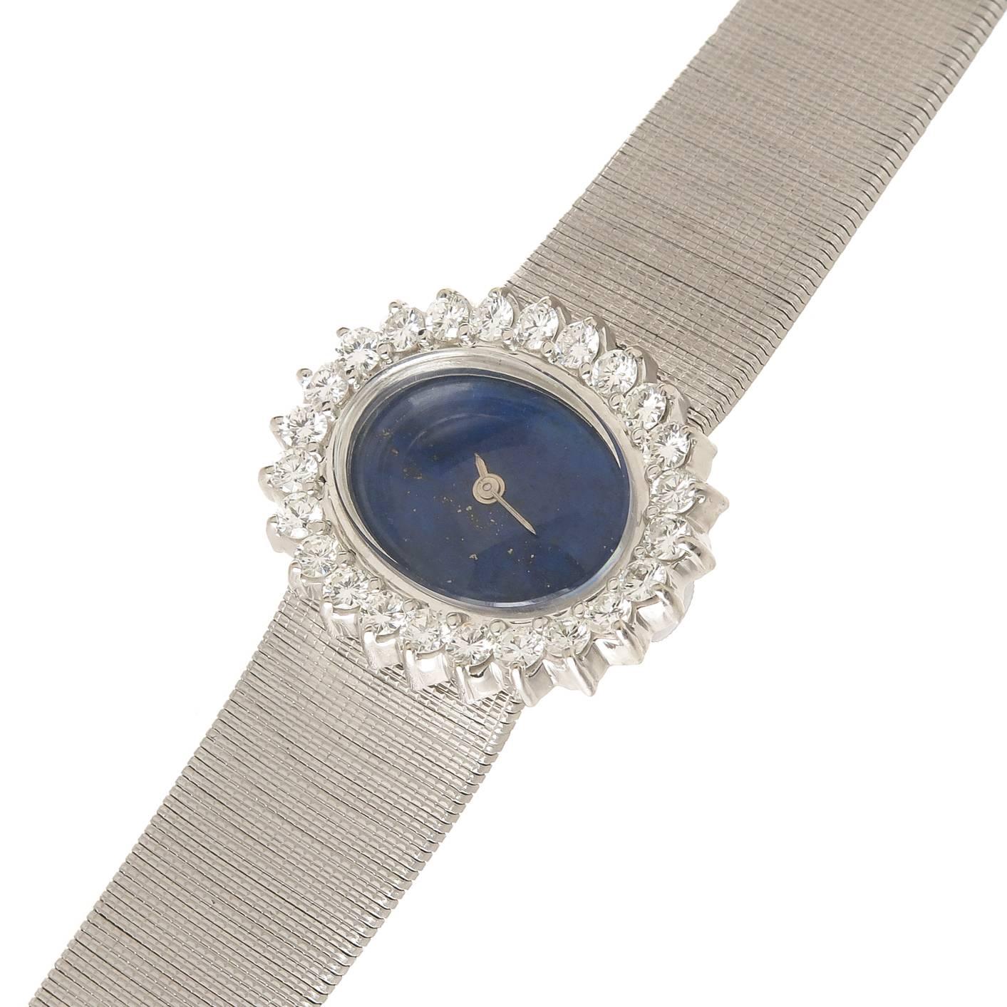 Circa 1970s 14k white Gold ladies watch by M & W Ullman, Switzerland, 17 jewel manual wind movement, lapis Lazuli Dial with White Gold hands. The watch measures 1 X 3/4 inch oval and is set with 24 Round Brilliant cut Diamonds totaling 1.70 carat