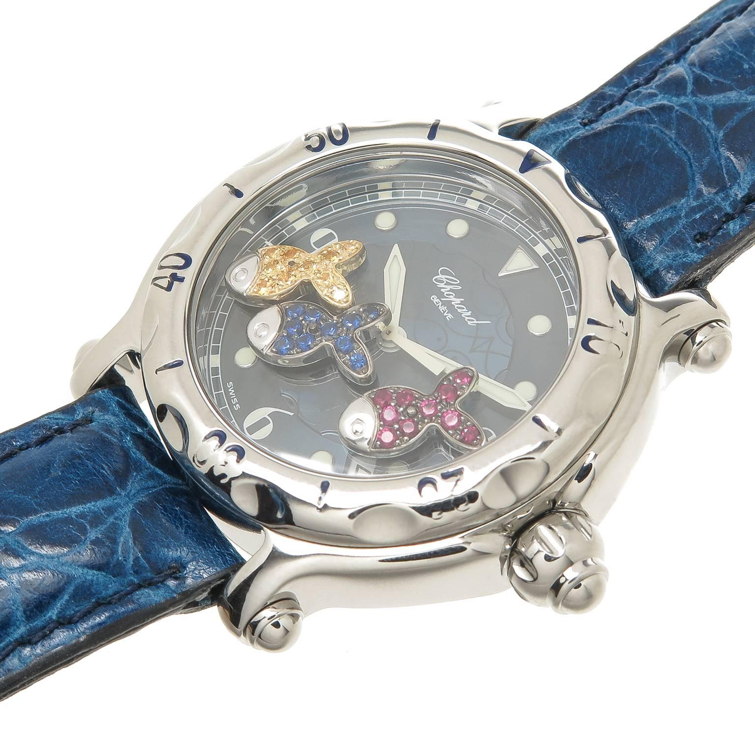 Circa 2012 Chopard Happy Sport Wrist watch, 38 MM Stainless Steel Water Resistant case with rotating Bezel, Quartz Movement, Navy Blue Dial with 3  floating fish that are set with Yellow Sapphire, Blue Sapphire and Rubies. New Padded Navy Blue