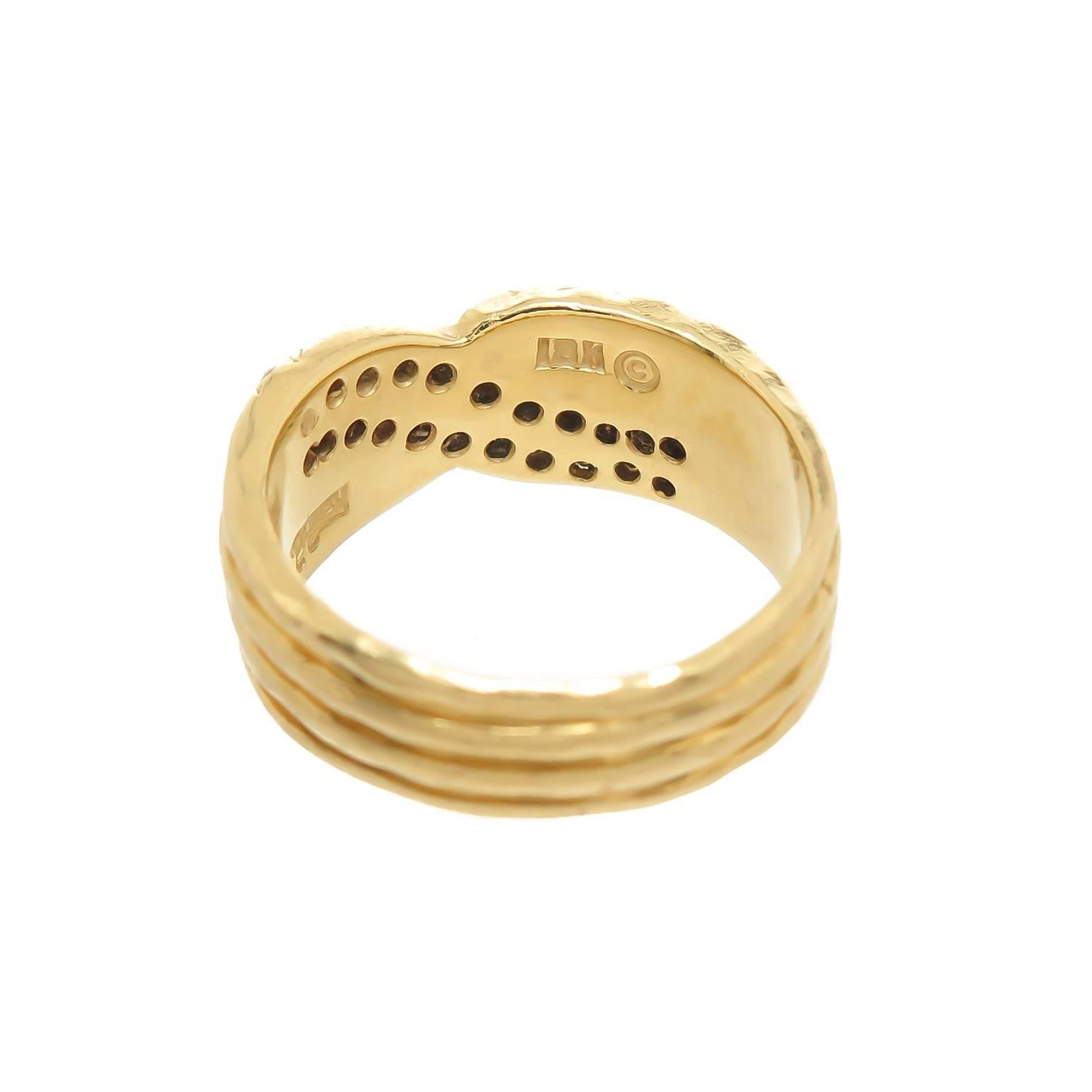 Circa 2000 Henry Dunay 18K yellow Gold Ring with the signature Dunay hammered finish, set with 2 rows of Round Brilliant cut Diamonds totaling .75 Carat. Measuring 3/4 inch across the top and 5/16 inch wide, finger size = 7 Comes in the original box