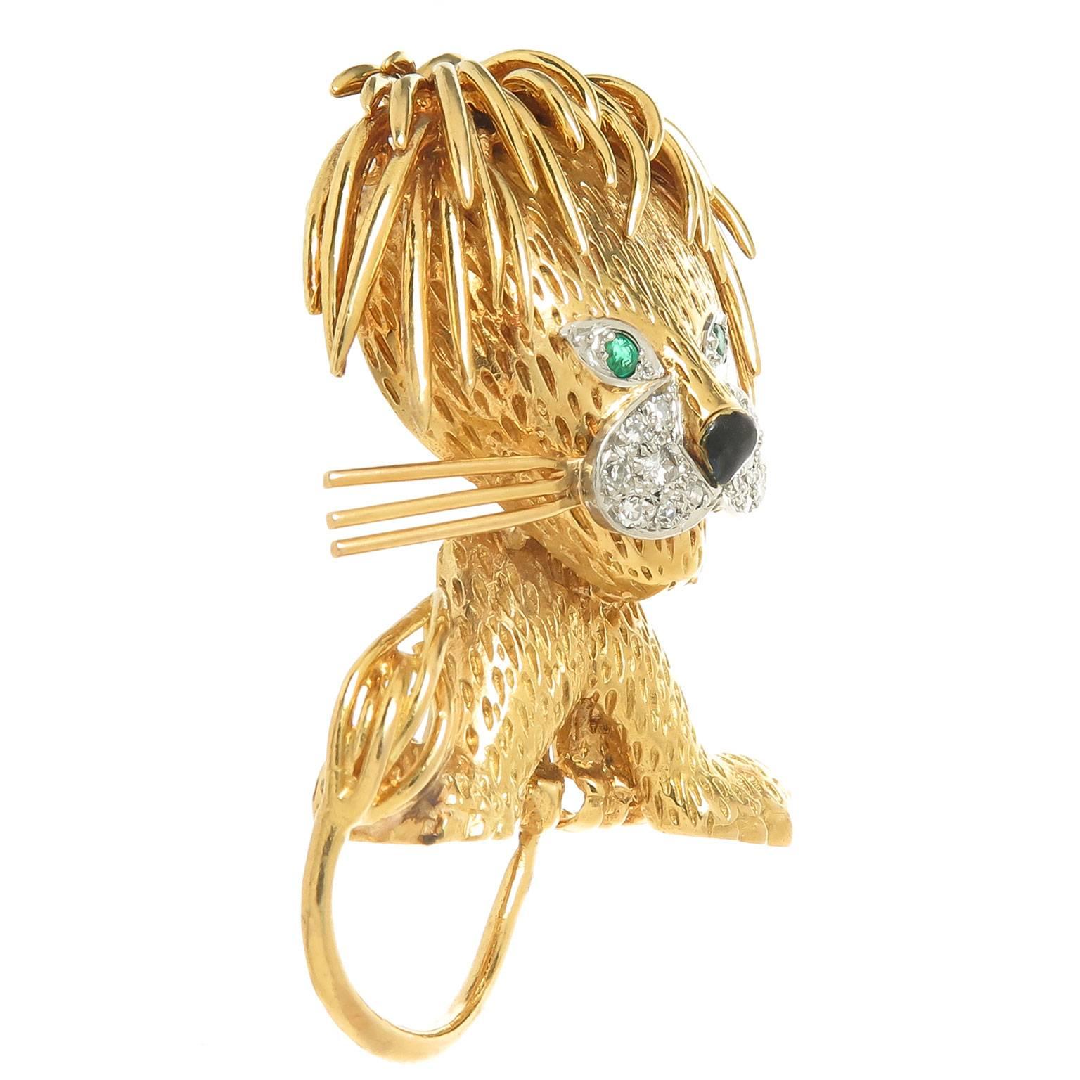 Circa 1970s Van Cleef and Arpels France 18K yellow Gold Lion Clip brooch, measuring 2 inch in length and 1 1/8 inch wide. finely detailed, set with Emerald Eyes and  Diamonds around the mouth and further decorated with a Black enamel nose, this is