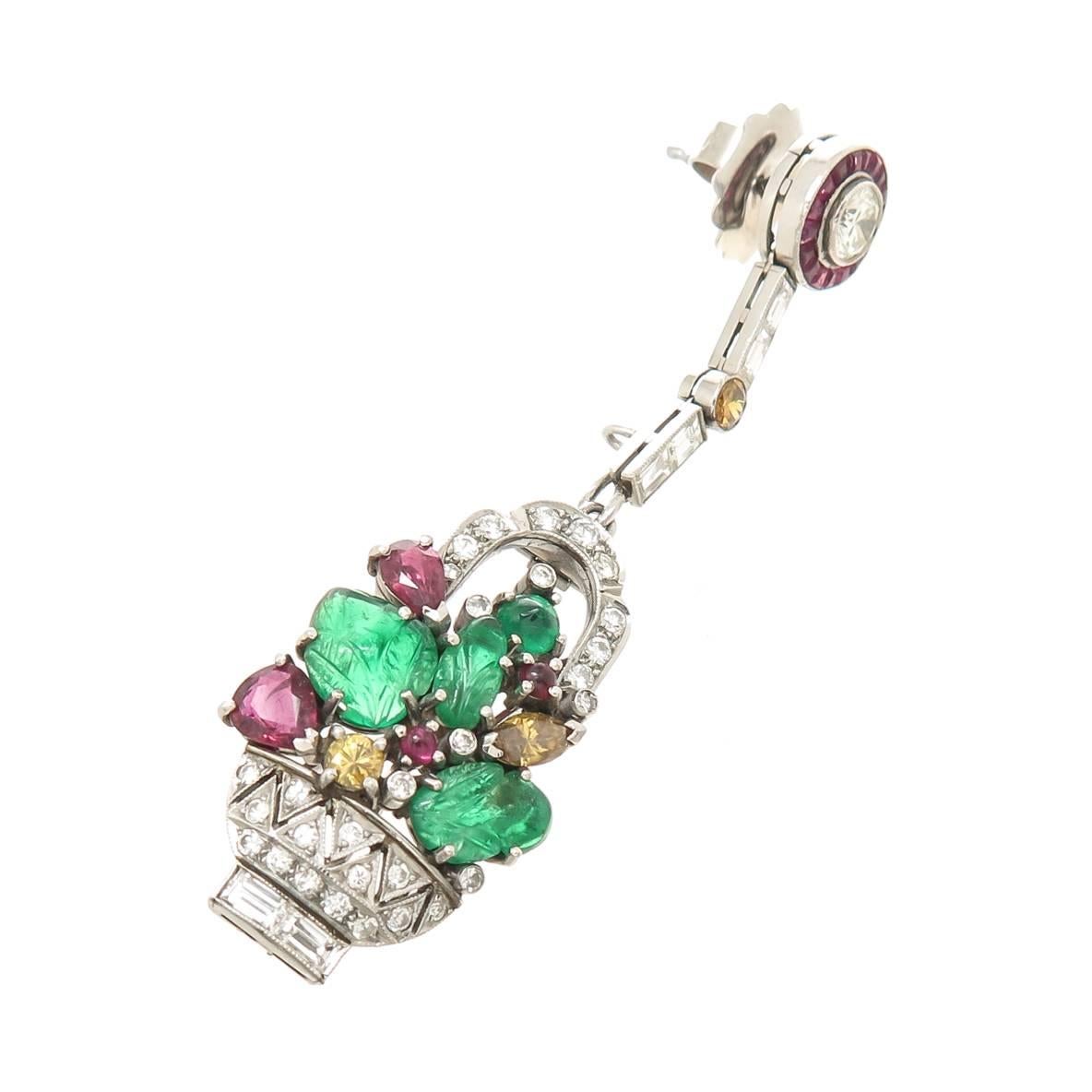 Circa 1950 Platinum Tutti Frutti, Fruit Basket convertible Dress Clip, Earrings, set with Round, Baguette and Fancy Color Diamonds and further set with Carved and Cabochon Emeralds, Cabochon and Pear shape Rubies. Diamond Total = 2.50 Carats.