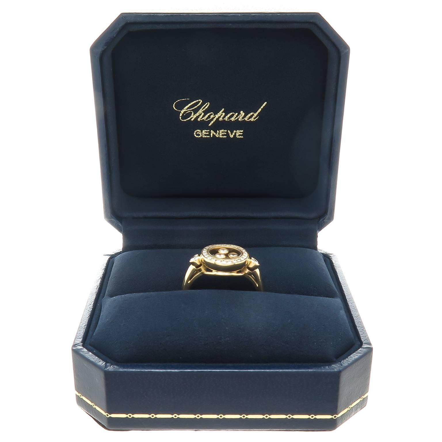 Circa 2005 Chopard 18K Yellow Gold Happy Diamond Ring, measuring 7/16 inch in diameter and having a bezel set with Round Brilliant cut Diamonds totaling 1/4 carat and Three floating Diamonds totaling .15 Carat. Finger size = 6 1/2. Comes in Chopard