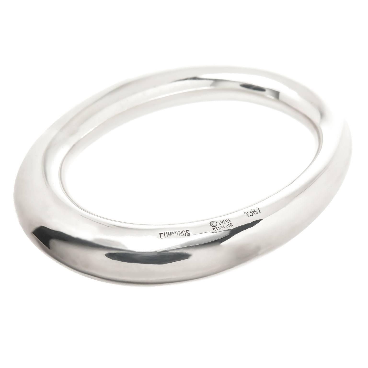 Circa 1980s Angela Cummings Sterling Silver Bangle Bracelet. The hallow bracelet measures just over 3/8 inch thick with an inside measurement of approximate 7 inch.