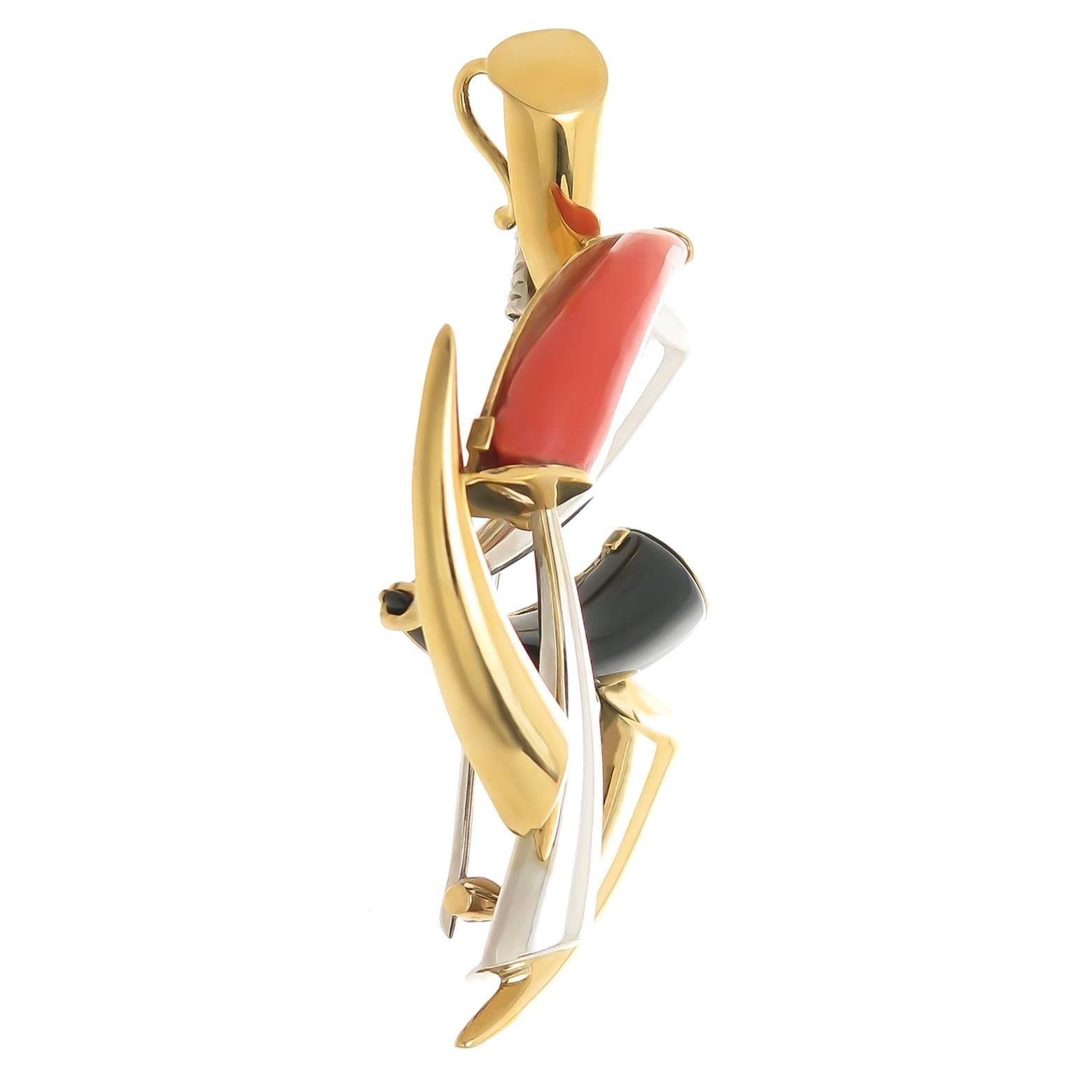 Circa 1960s Cartier Mid Century Modern Pendant Brooch 18K Yellow and White Gold and set with Coral and Black Onyx, measuring 2 1/2 inch in length and 1 1/2 inch wide. Signed, Numbered and extremely well made.