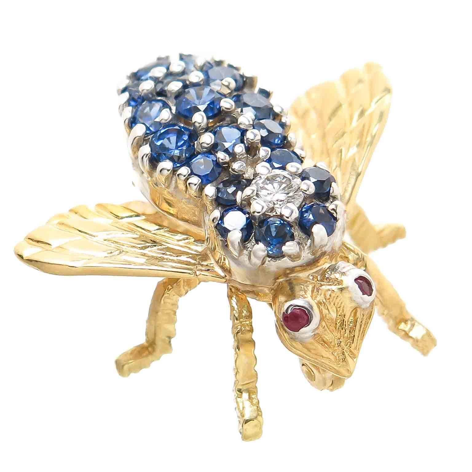 Circa 1980 Herbert Rosenthal 18K Yellow Gold Bee pin, measuring 1 inch from wing tip to tip and 3/4 inch in length. Set with Round brilliant cut Sapphires of fine color, a .04 Carat Diamond and Ruby Eyes. 