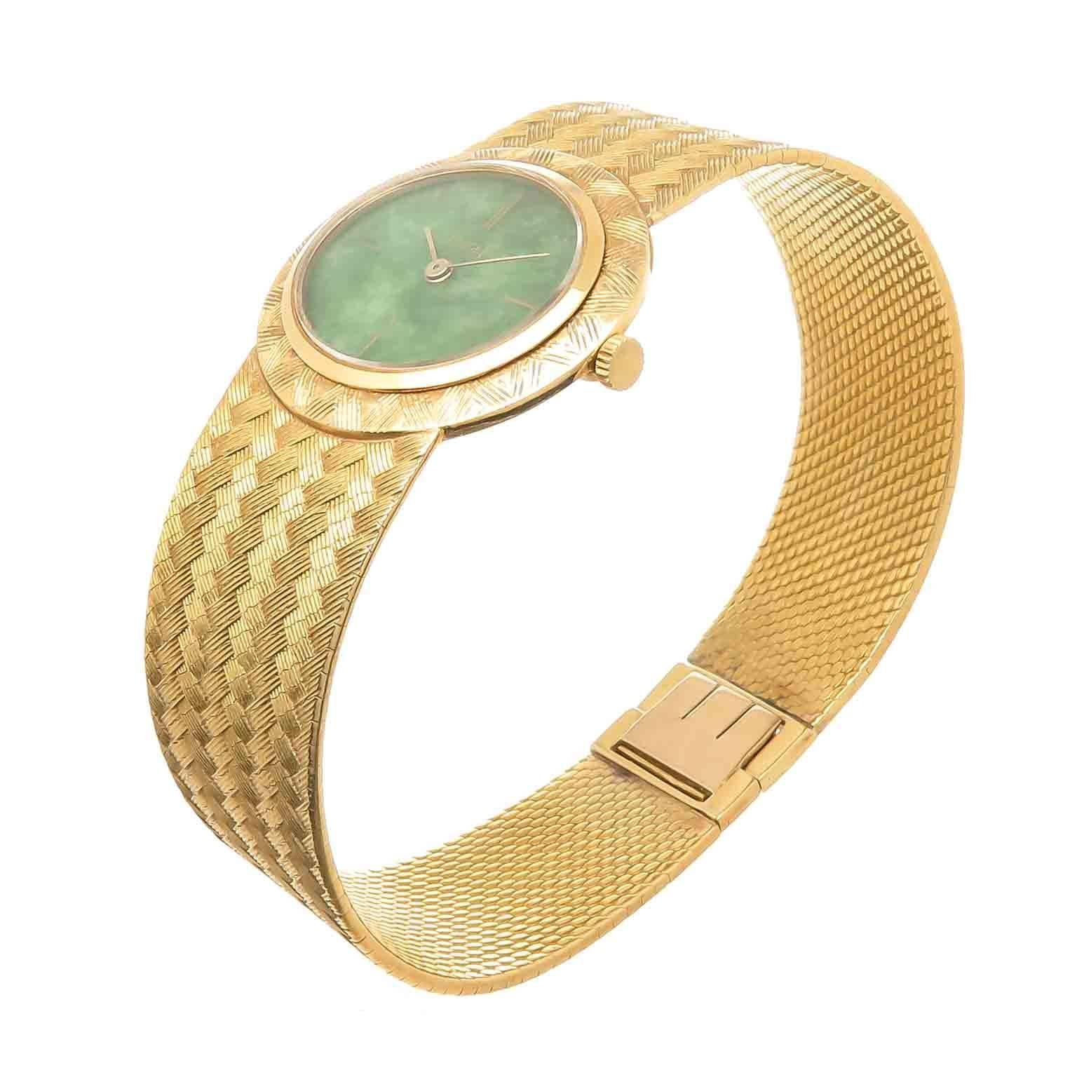 Circa 1980 Piaget 18K yellow Gold Wrist watch, 27 X 24 MM Oval case with Light textured Bezel. Mechanical winding Movement, Jadeite Stone Dial and Gold Hands. 3/4 inch wide Textured Mesh Bracelet. Total watch length 7 1/4 inch. Recently serviced and