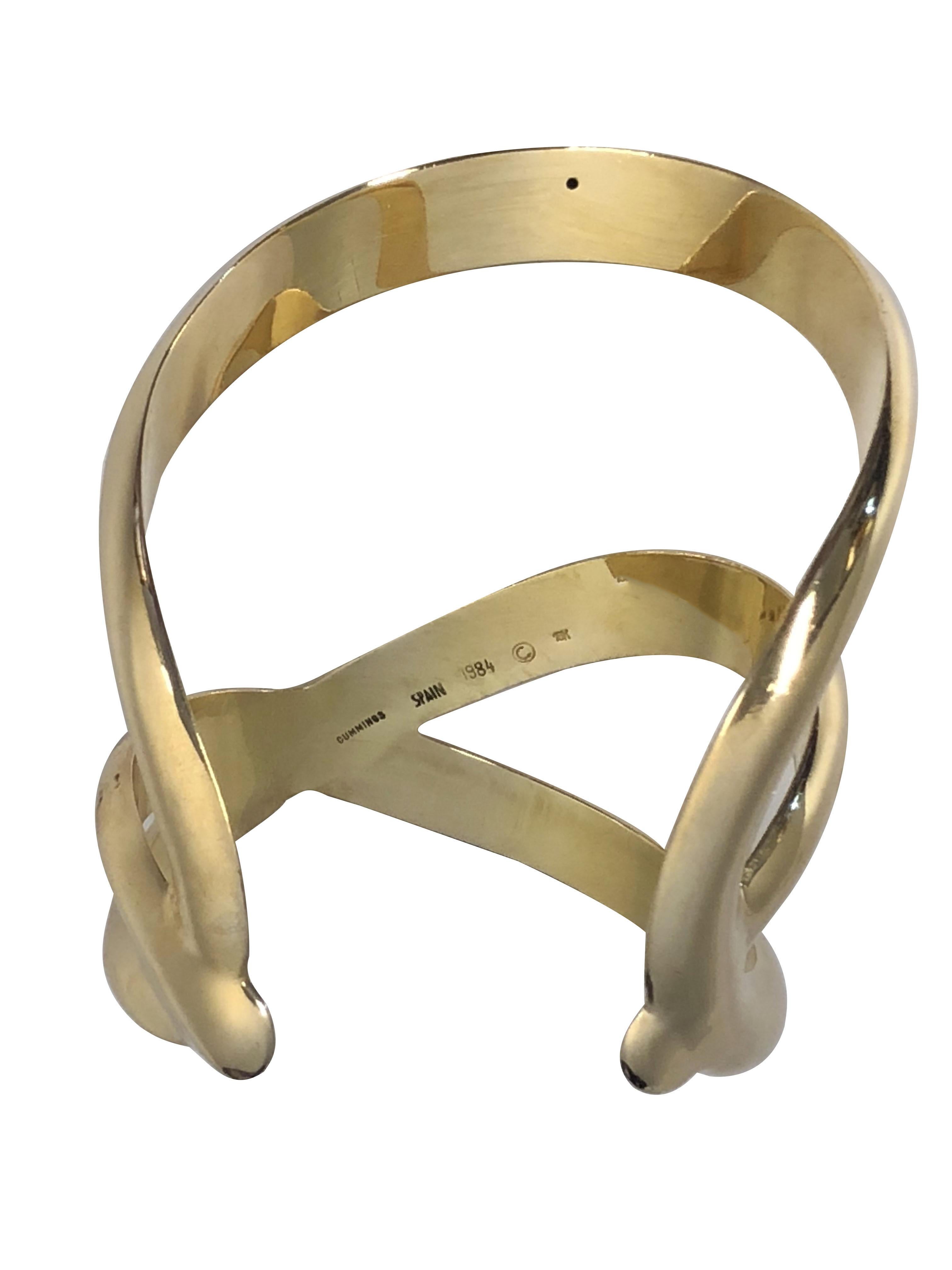 Circa 1984 Angela Cummings Studios 18k yellow Gold Cross over Design Cuff Bracelet, measuring 2 3/4 inches in length, 2 3/4 inches wide and weighing 55.3 Grams. inside measurement of 5 inches with a 1 1/4 inch wide opening, 