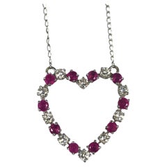 Collier vintage avec pendentif en forme de cœur ouvert, en or blanc, serti de diamants et de rubis
