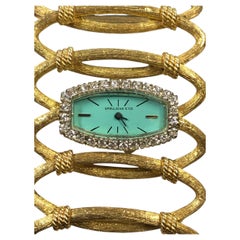 Vintage-Armbanduhr aus den 1960er Jahren mit breitem Armband aus Gelbgold und Diamanten von Spaulding &