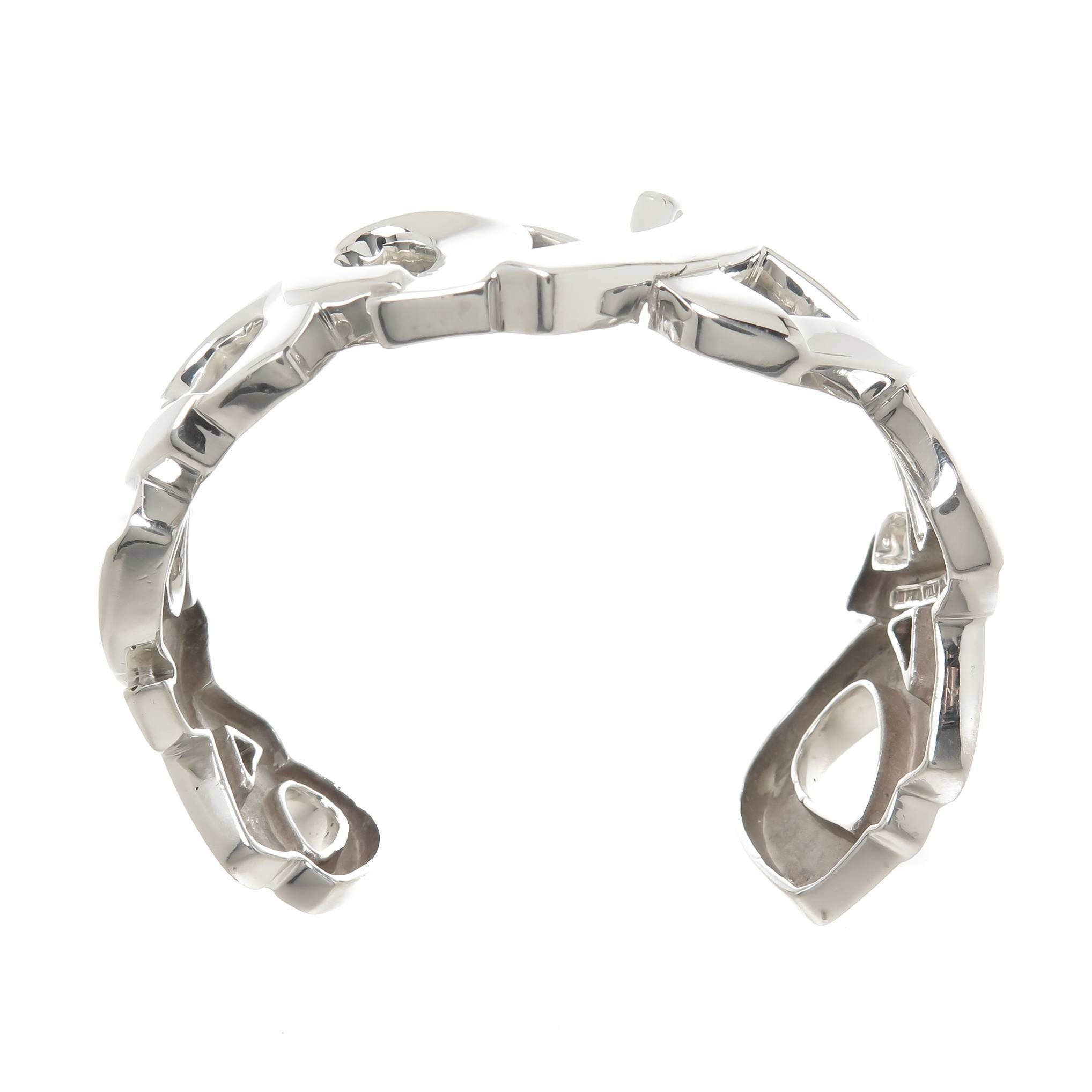 Circa 1980s Paloma Picasso for Tiffany & Company Sterling Silver XO Love and Kisses Bracelet, measuring 1 1/8 inch wide, inside measurement 6 1/4 inch with a 1 inch wide opening, the bracelet is pliable and can be bent open or closed just a bit for