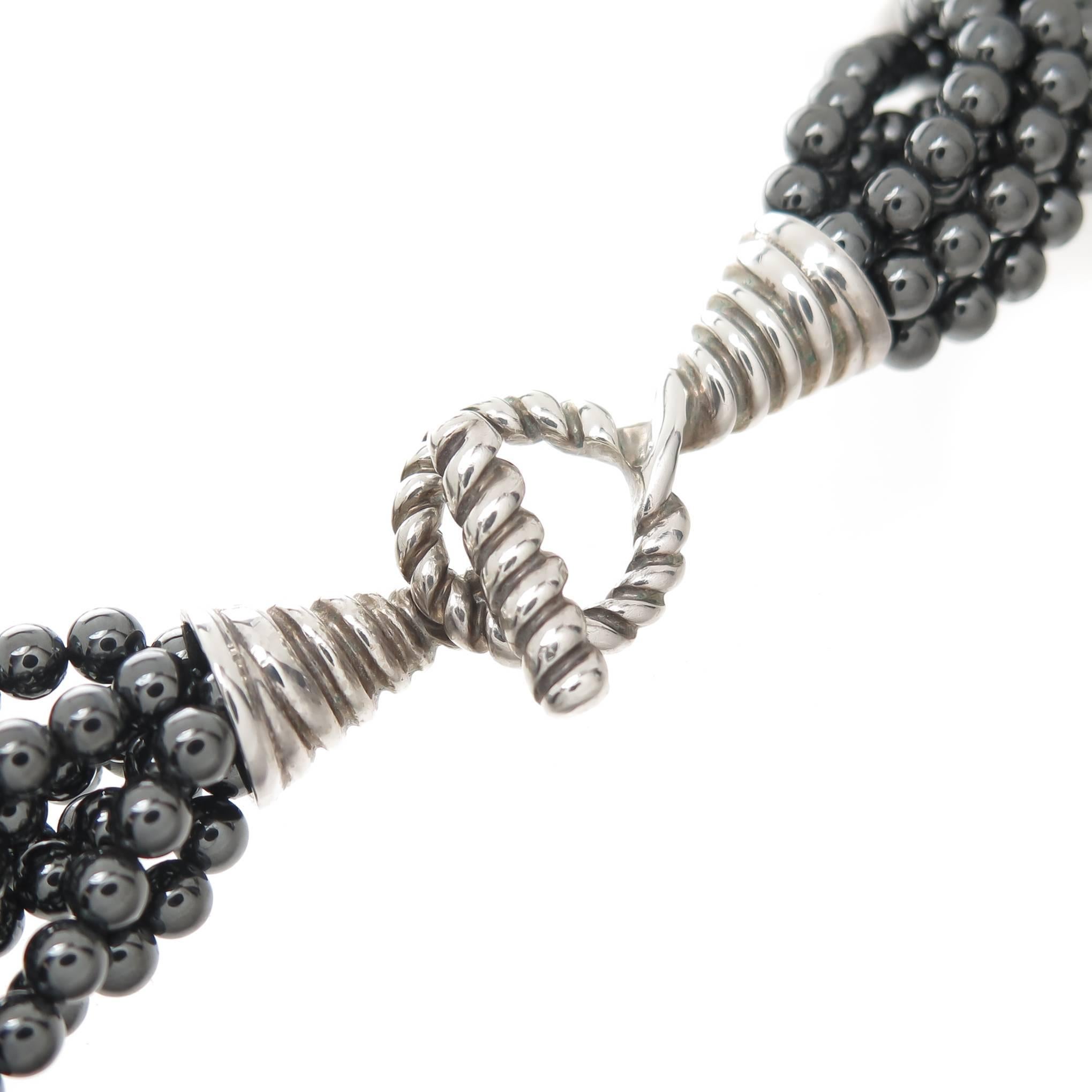 Circa 2000 Tiffany & Company Hematite Bead Torsade Necklace, consisting of several strands of 4 MM Grayish Black Hematite Beads and having a sterling silver toggle clasp. The necklace measures 17 1/2 inches in length and 3/4 inch wide. Comes in
