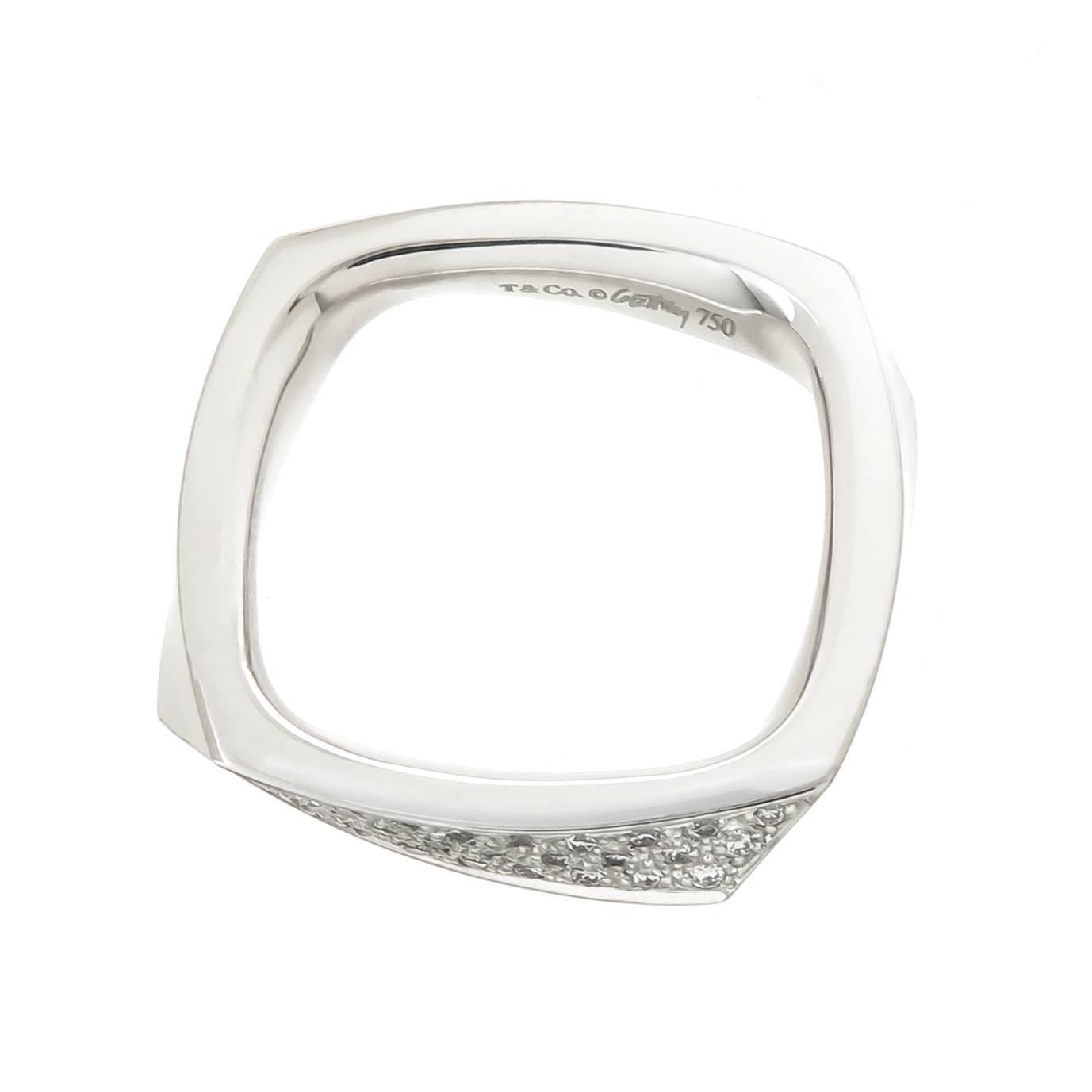 Circa 2010 Frank Gehry for Tiffany & Company 18K White Gold Torque Band Ring. Measuring 1/8 inch wide and set with Round Brilliant cut Diamonds totaling .15 Carat. Finger size = 5.