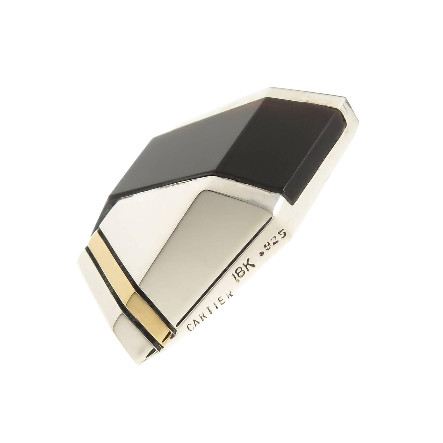 Circa 1980 Cartier 18K yellow Gold, Sterling silver and Onyx Earrings, measuring 1 1/4 inch in length and 7/8 inch wide. Having a post back, the earrings are in excellent condition and come in a Suede Cartier Pouch.
