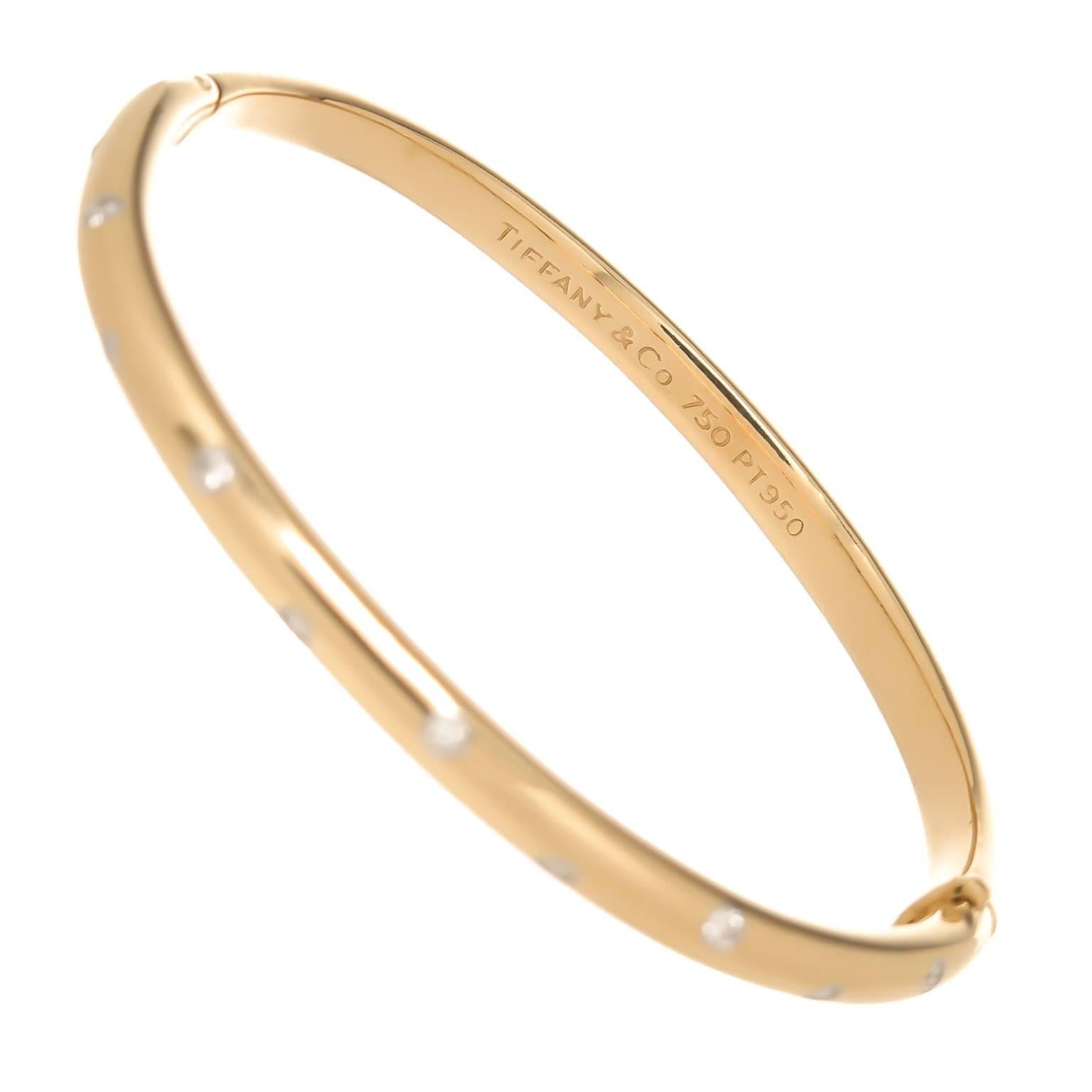 Circa 2000 Tiffany & Company Etoile Collection 18K Yellow Gold and Platinum Bangle Bracelet. Set with 10 Round Brilliant cut Diamonds totaling .40 Carat. Measuring 4 MM wide, wrist measurement 6 1/2 inch.