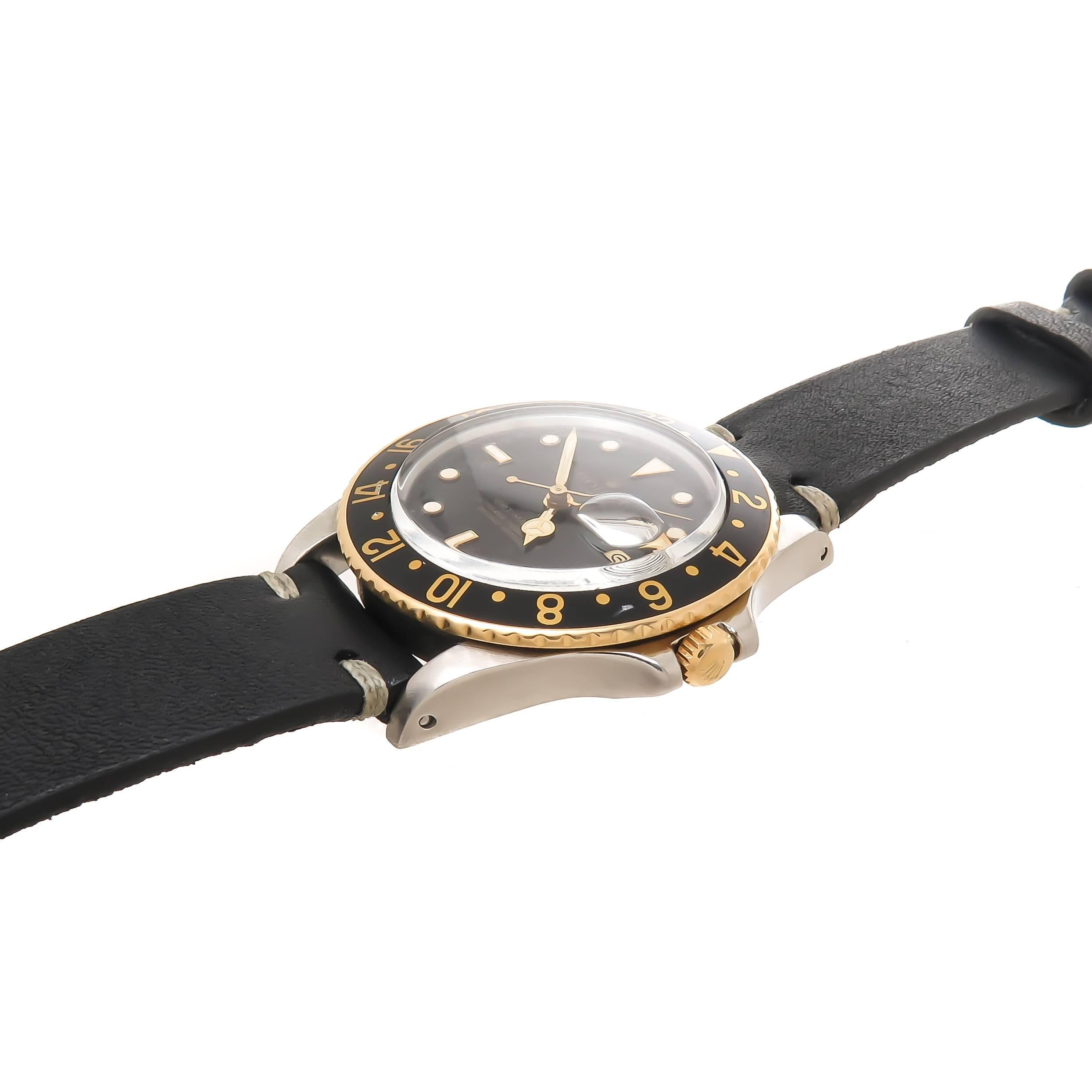 Circa 1985 Rolex GMT Master,  Reference 16753  Wrist Watch, 38 MM Stainless Steel case with Yellow Gold Rotating Bezel, Automatic, self winding Caliber 3075 movement,  Original, Mints condition Black Dial with Gold Gilt lettering, Gold Bezel markers