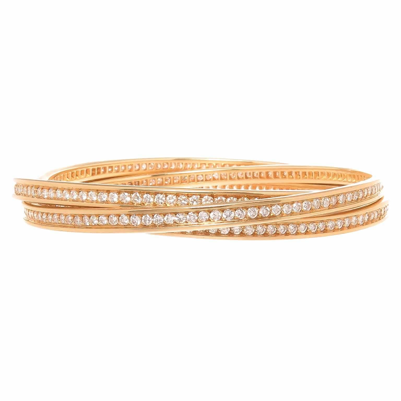 Circa 2005 Cartier Trinity Collection 3 Band Diamond set Bracelet, each measuring 3.5 MM wide and set with Round Brilliant cut Diamonds totaling 7 Carats for the 3 bands and grading as G in Color and VS in clarity. Inside measurement / wrist size =