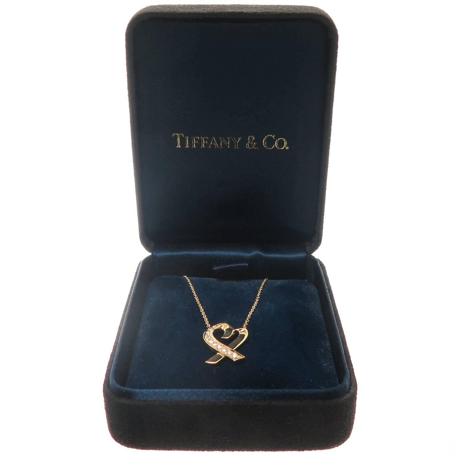 Circa 1990s Paloma Picasso for Tiffany & Company 18K Yellow Gold and Diamond Open heart Pendant Necklace. The Heart Measures 5/8 inch in length and suspended from a16 inch chain. Set with Round Brilliant cut Diamonds totaling .20 Carat. Comes in the