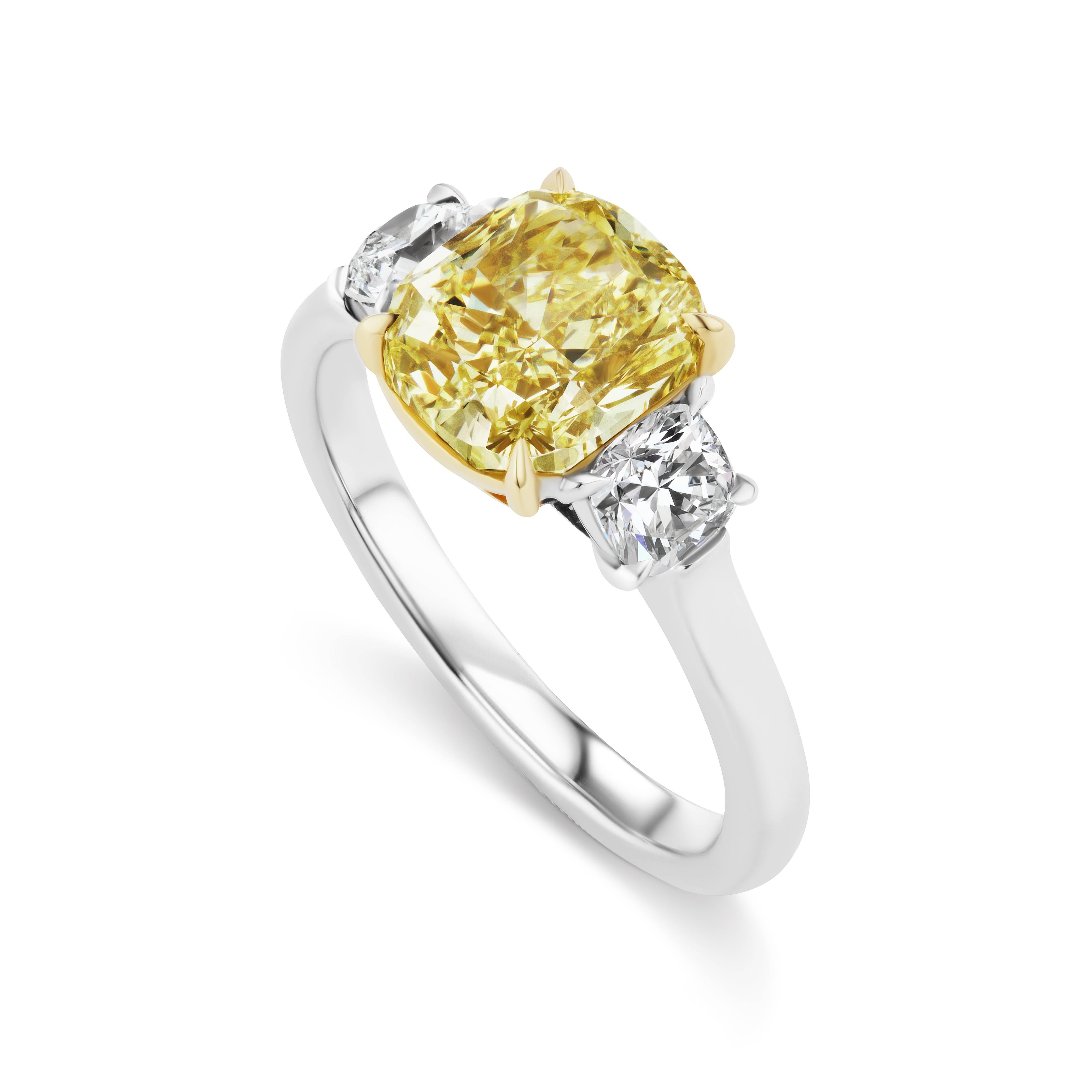 This Scarselli Classics  2.52 carat Fancy Yellow VS1 Cushion Cut diamond is flanked by a pair of white cushion cut diamonds that total .58 carats.  The diamonds are mounted in Platinum with 18 karat yellow gold.  This ring from the Scarselli Classic
