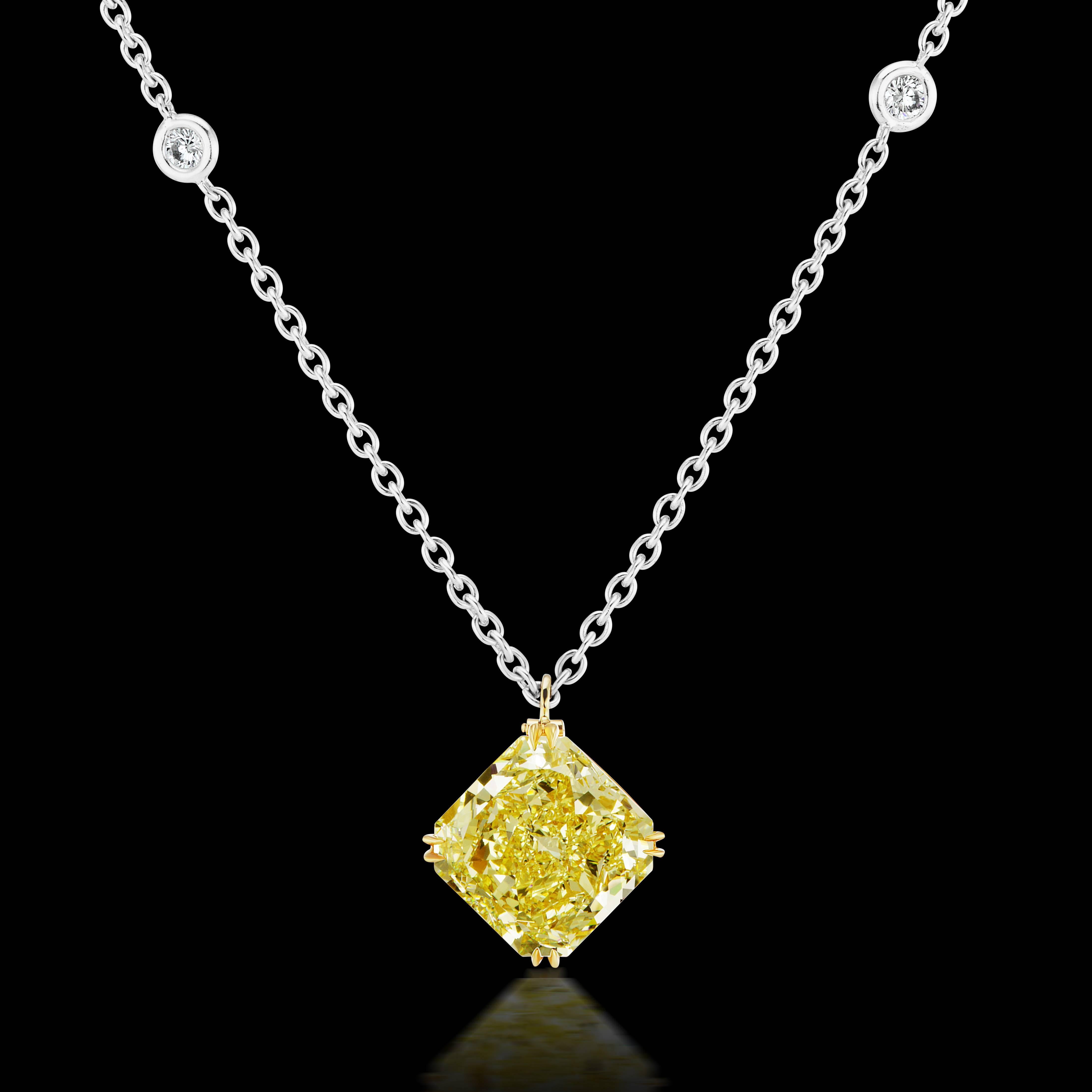The ultimate wearable luxury, this 8.09 carat Fancy Yellow Radiant Cut Diamond VVS1 Clarity set in 18 karat yellow gold and suspended from an 18 karat white gold station chain with small white diamonds totaling .20 carat.  This spectacularly cut