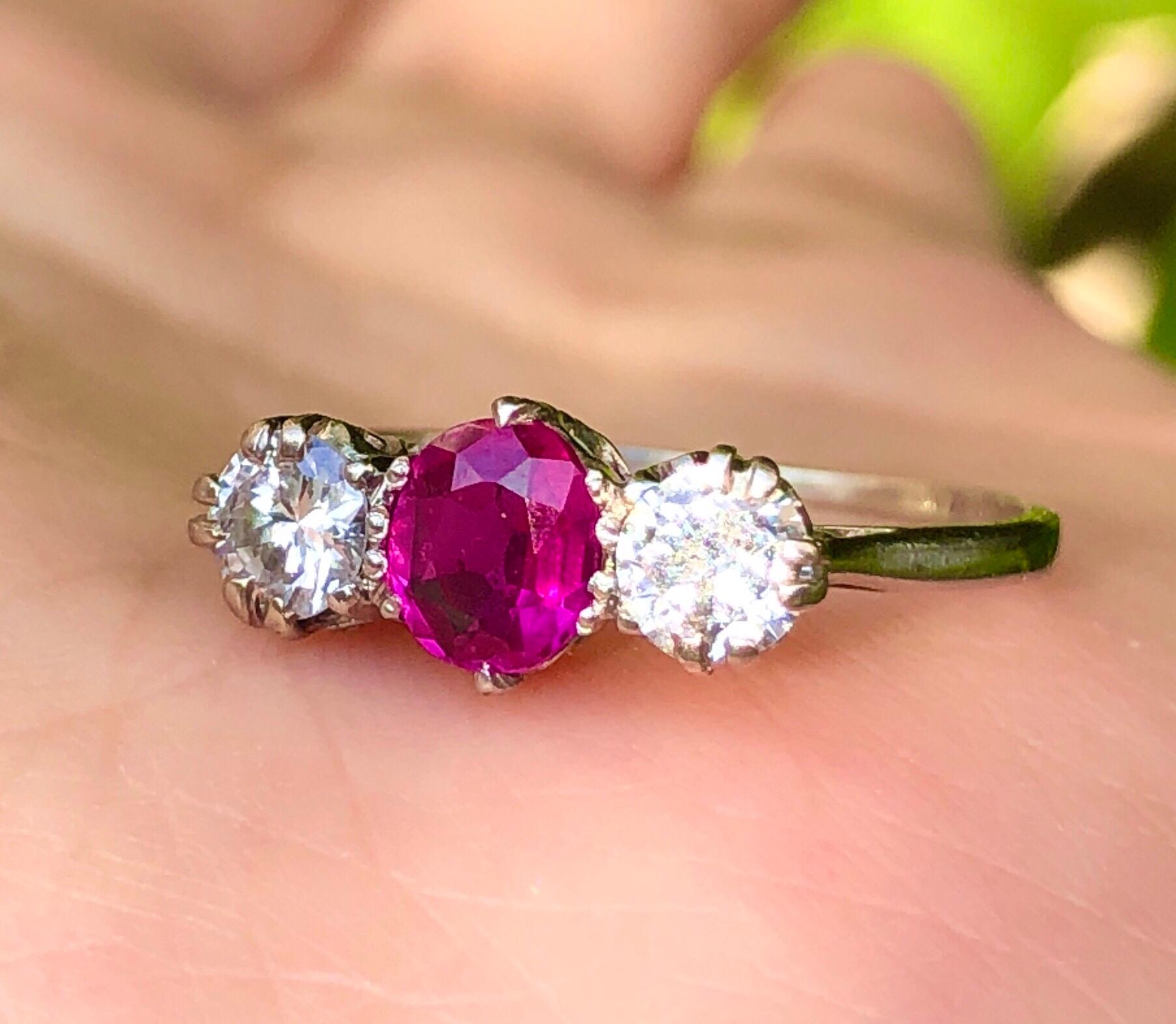A really beautiful Platinum ring that was made circa 1900-1910. The ruby is a gorgeous pinkish 0.5 carat stone and is flanked on either side by clear white diamonds weighing half a carat each. It would be an ideal engagement or Ruby anniversary