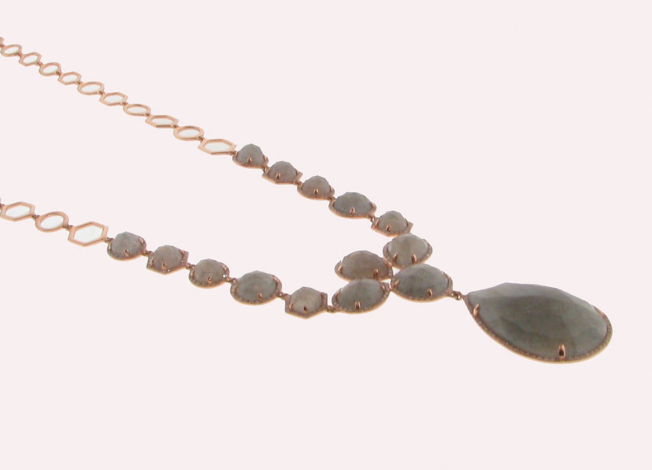 The necklace has pear shape labor drives stones. Each stone is surrounded by diamonds