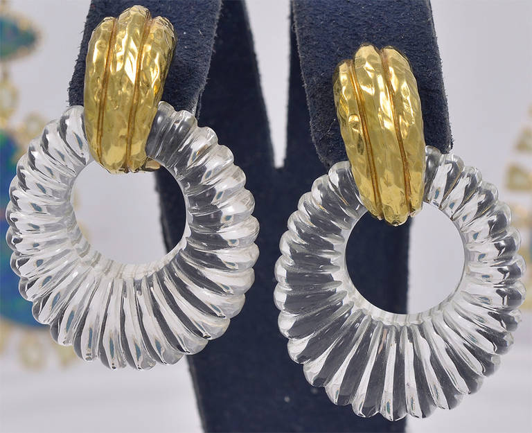 The 18k gold hoop earrings have fluted crystal attached hoops   The crystal piece is removable.