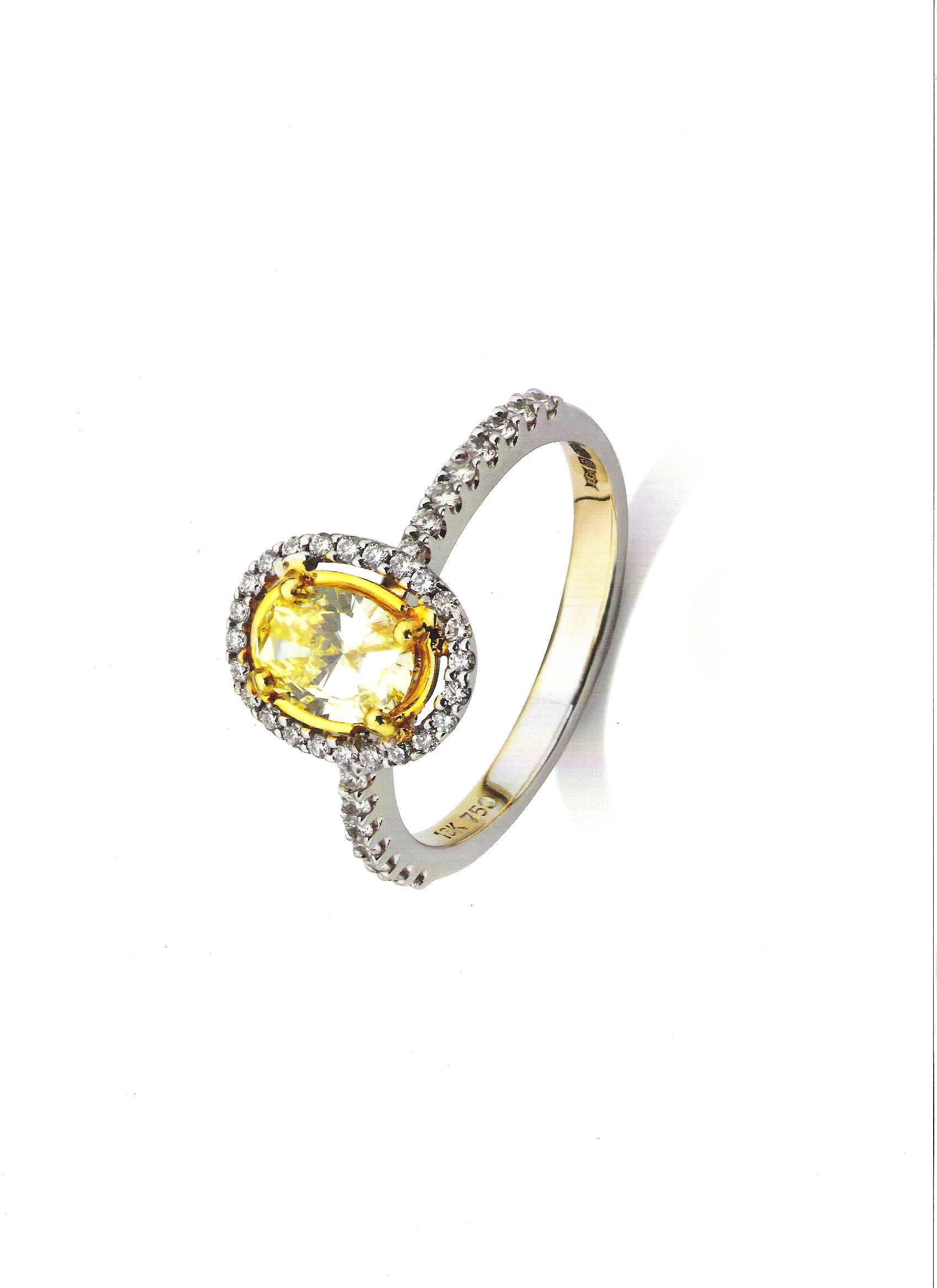 Comprising an IGI Certified, 0.63 Carat, Fancy Yellow, Oval cut centre stone – Set in 18 Carat White Gold with 40 individual brilliant diamonds totalling 0.20 carats. – 

Total diamond weight = 0.83 carats

Perfect as an engagement ring or as a