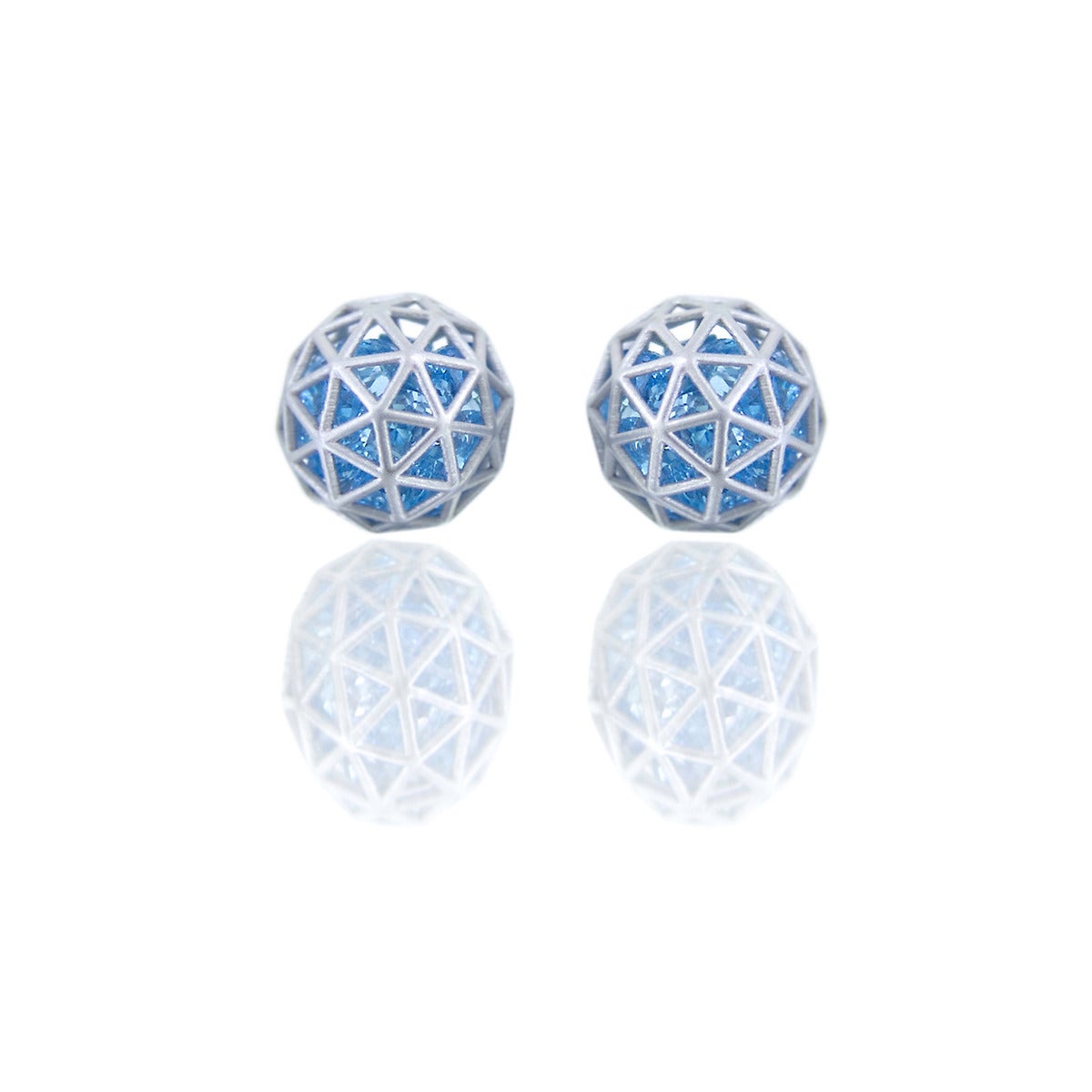 From the Wired Collection, stud earrings in 18k white gold with loose blue topaz (6 cts). Geodesic pattern, on posts. Diameter 9mm or approx 3/8