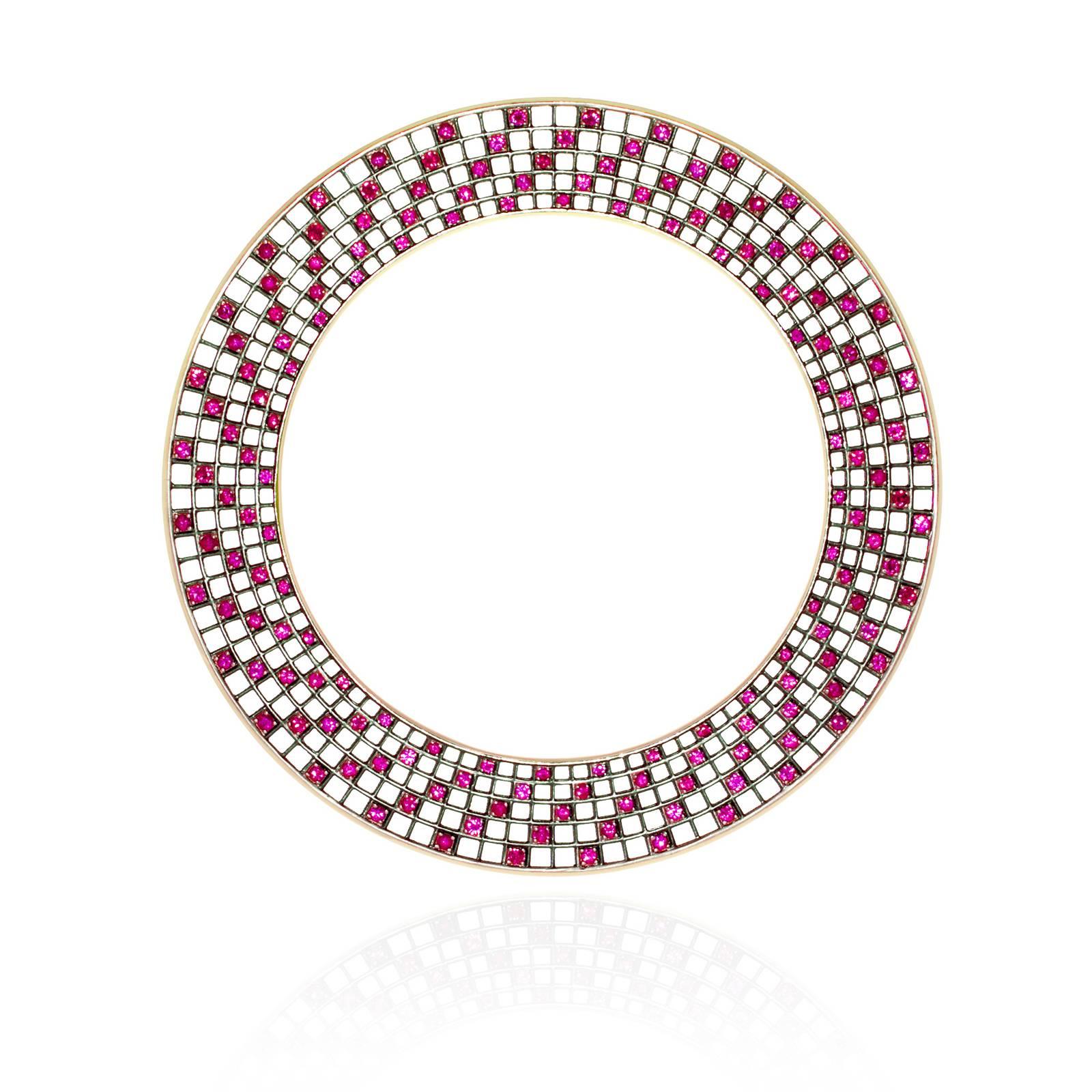 From the Wired Collection, a disc-shaped bangle with rubies (10 cts) set in a spiral pattern on a blackened 18k yellow gold grid. Exterior and interior edges are polished 18k yellow gold. Double-sided. Height 14mm or approx 1/2