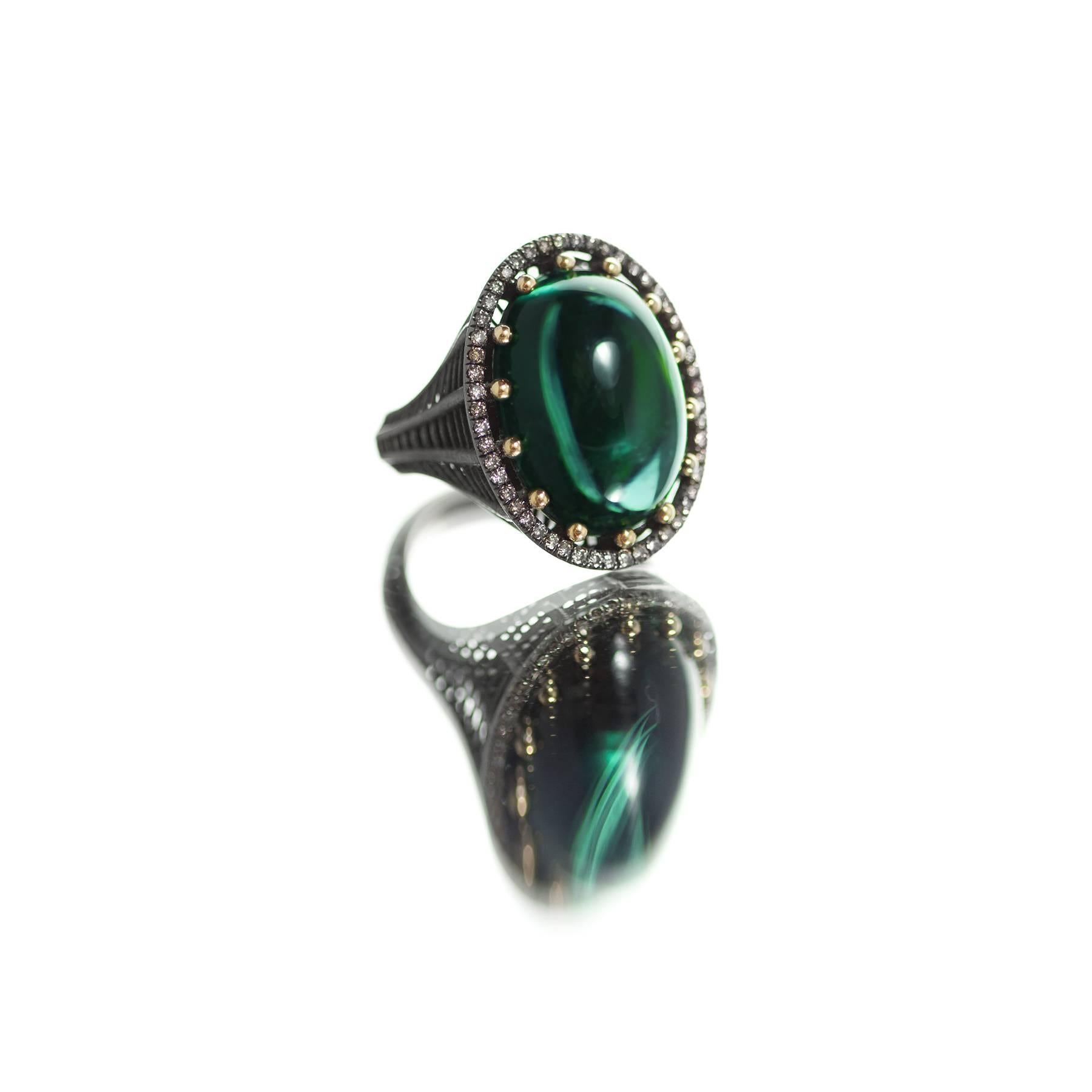 A cocktail ring in blackened 18k yellow gold with ball prong-set green tourmaline cabochon (17 ct) and champagne diamond pavé (0.52 cts). Cabochon is 13 x 18mm (or roughly 1/2 x 3/4