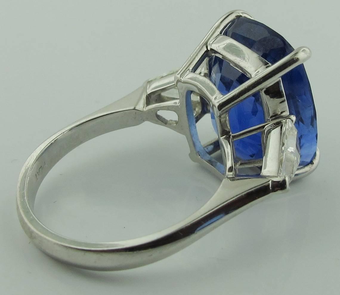 This stunning and rare 16.35 carat Blue Sapphire comes with a GIA Certificate.  It is from Sri Lanka, UNHEATED stone.  Triangle shaped diamonds have a total weight of 1.20 carats. Set in platinum.  Ring size:  7