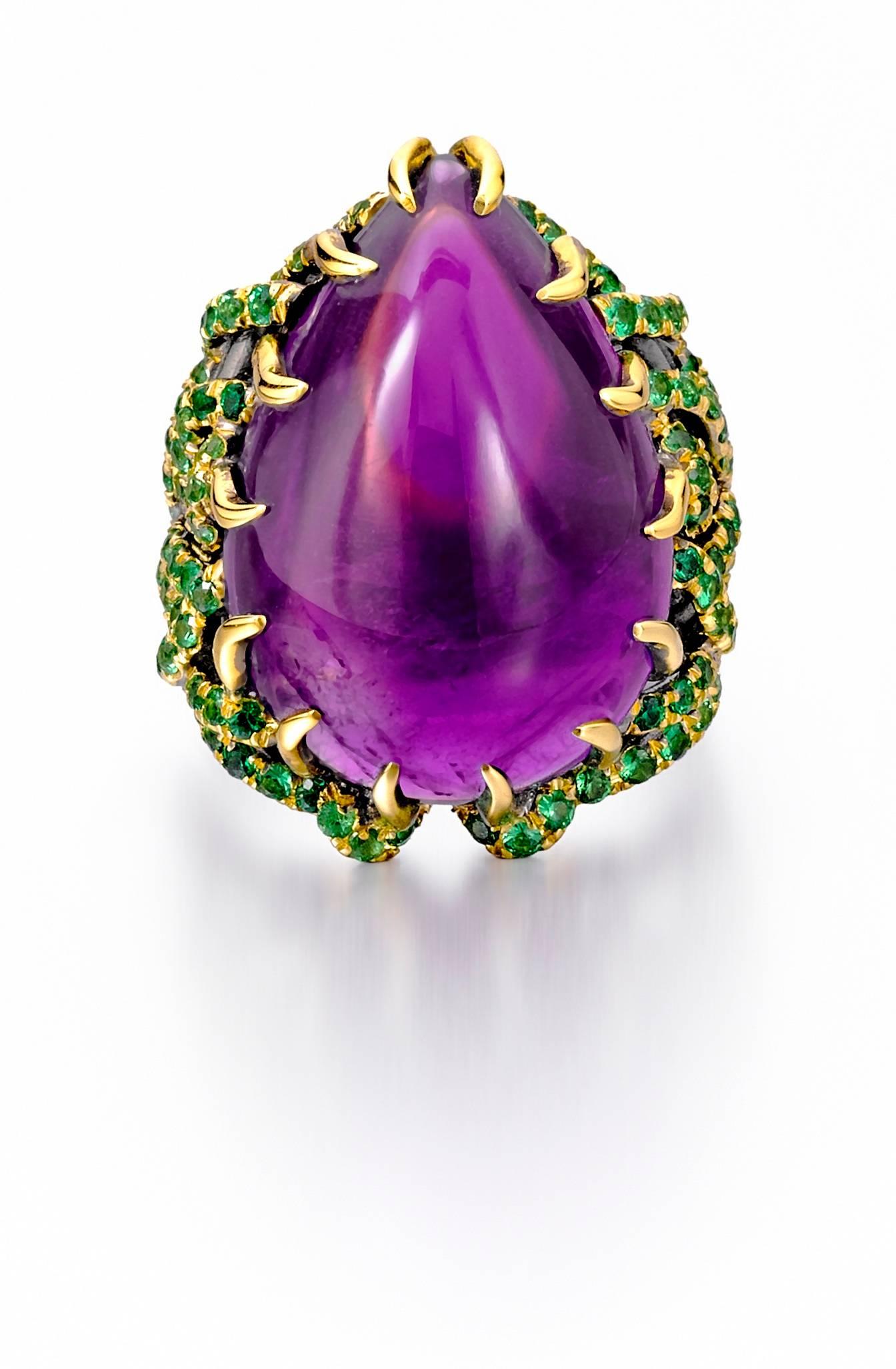 This gorgeous ring and earring suite was inspired by the true story of Marie Antoinette. Creating these labor-intensive pieces took months, with each pavé tsavorite being set by hand by a gem setter who has truly mastered his craft. The combination