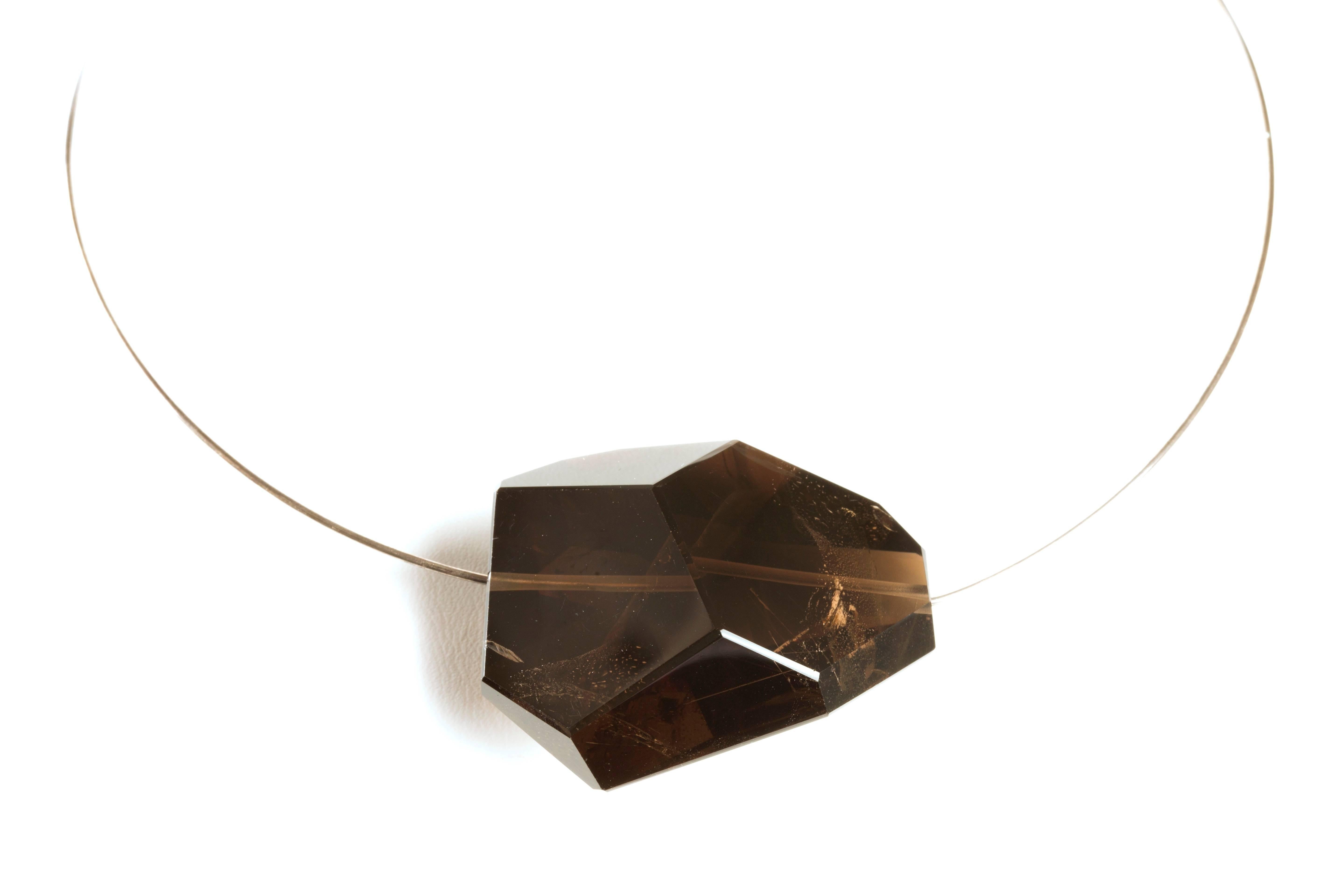 Very impressive Smoky Quartz Solitaire of 50 gms. (250 carats) of irregular faceted prismatic shape.  Simply and elegant with a very minimalistic look mounted in a Gold over Silver Italian thread with a round shape necklace.