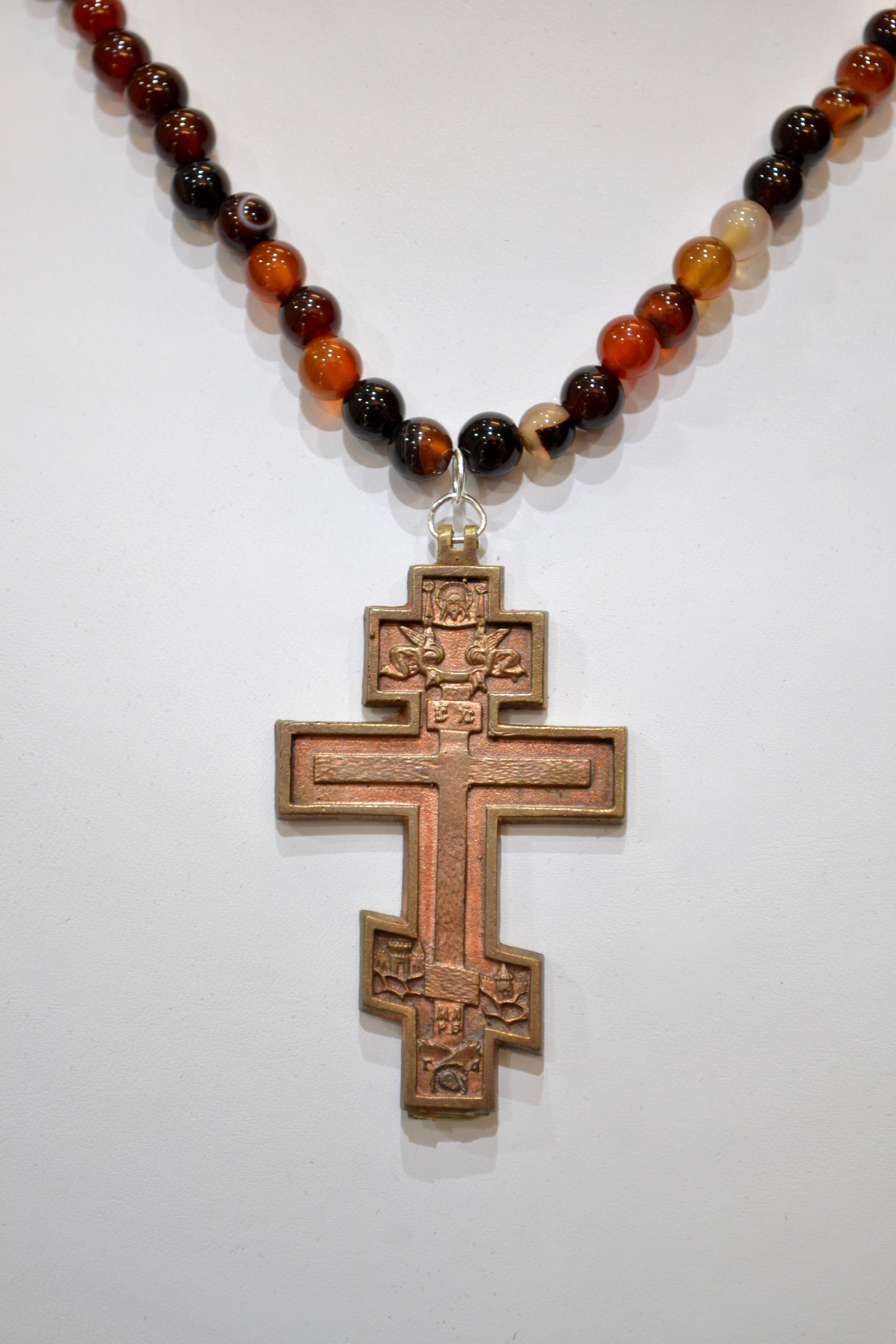 Post Medieval Bronze Cross Pendant. Professionally cleaned and polished to show original details. A beautiful necklace comprised of large red/brown agate beads accompanies the stunning pendant.