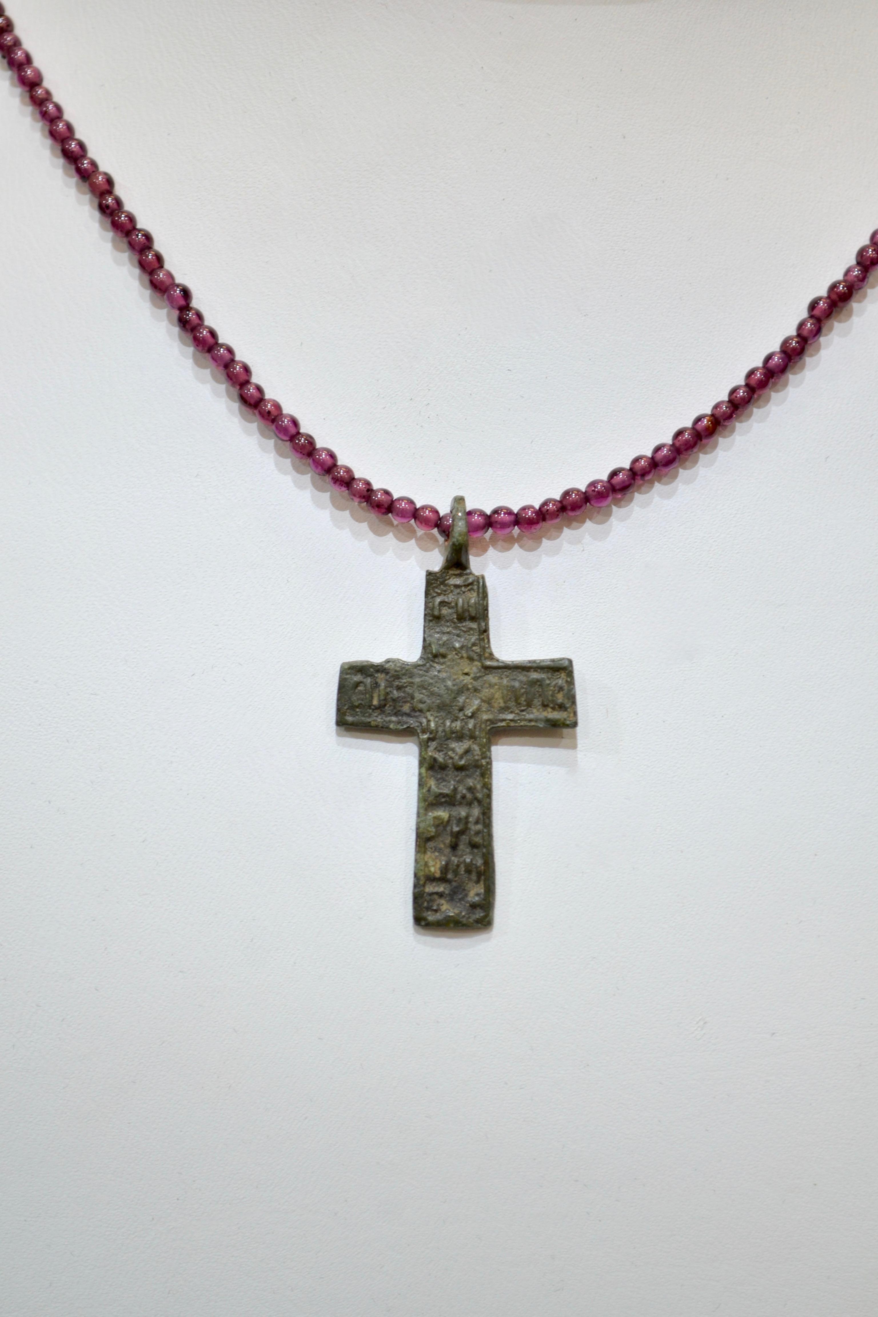 Late Medieval Bronze Cross Pendant. Professionally cleaned and polished to show original details. Obtained from an old British collection, acquired from the L.C.F. (London) Mounted on a beautiful garnet beaded necklace.