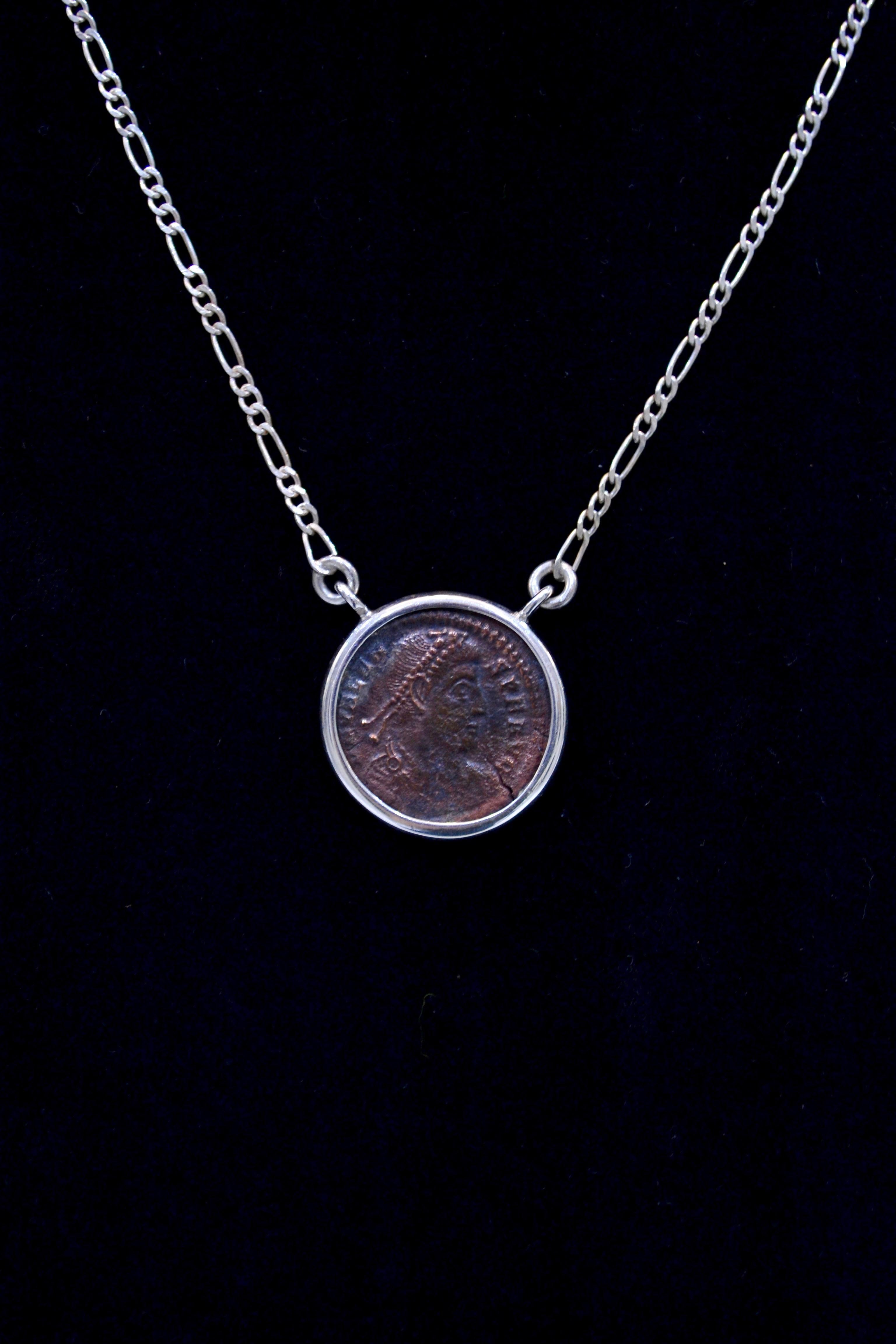 Antique Constantine The Great copper coin mounted on contemporary silver necklace. Ready to be worn!

Constantine was the son of Flavius Valerius Constantius, a Roman Army officer, and his consort Helena. He built Constantinople, created a new gold