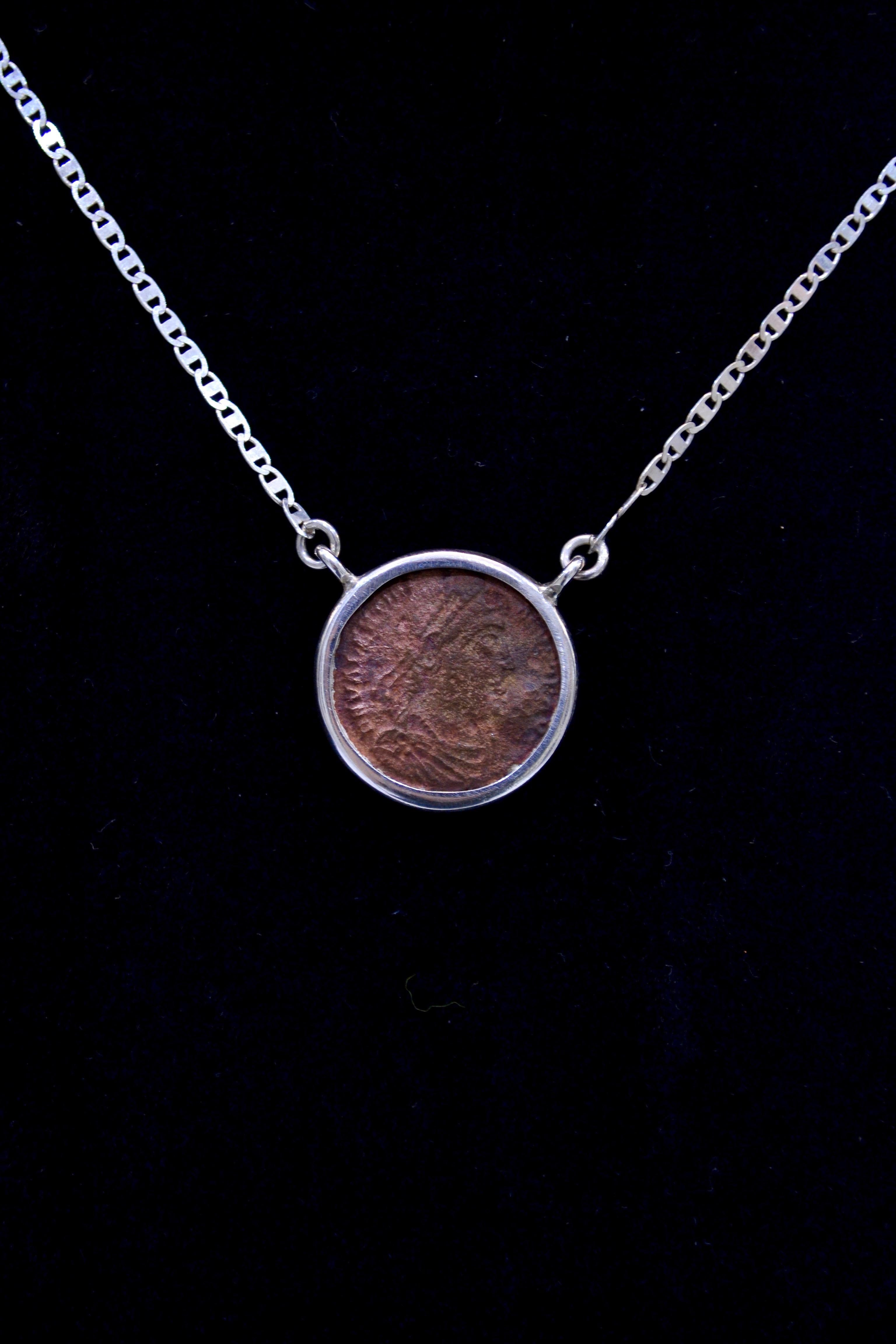 Antique Roman copper coin mounted on contemporary silver necklace. Ready to be worn!

Fully Flavius Julius Valens Augustus, he was given the eastern half of the empire by his brother Valentinian I after the latter's accession to the throne. Valens,