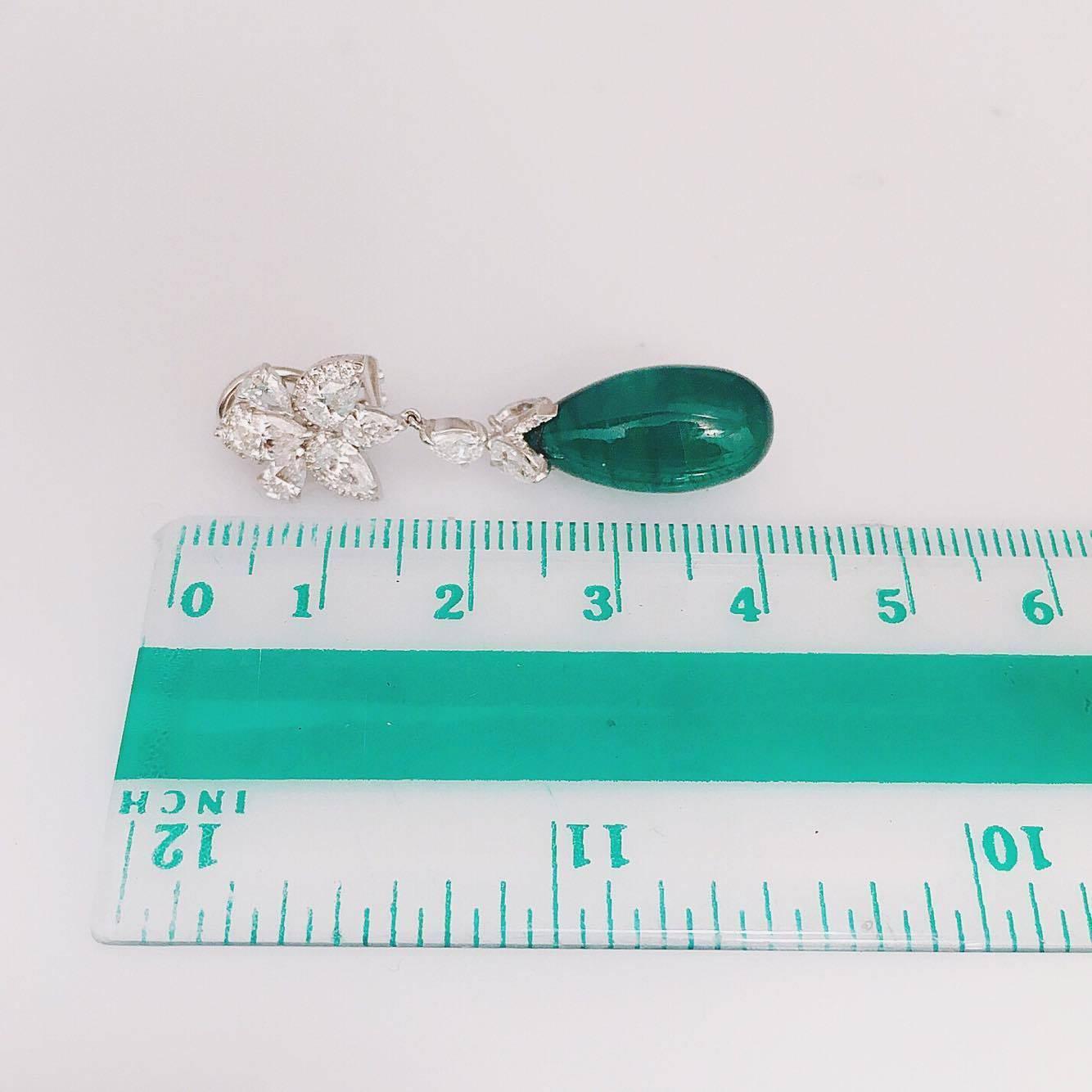 Wow! We handmade these one-of-a-kind emerald diamond earring with micro pave diamonds and pear shapes.
 
18kt white gold set with two oval cabochon emerald (21.78 carat) Vivid Intense Green AAA quality.
 
E color VVS1: diamond (3.43