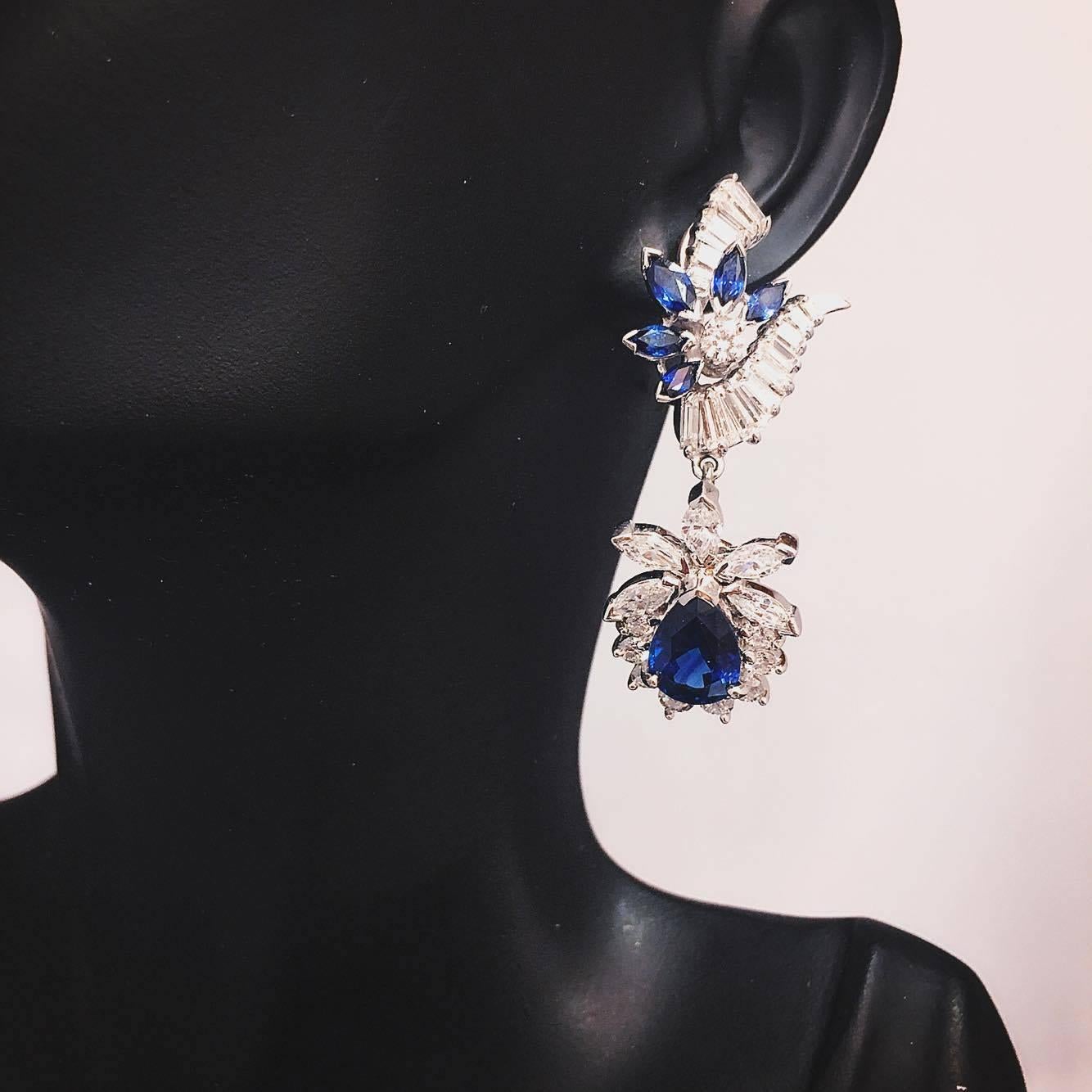 2 Pear shape deep rich blue sapphires totaling 6.54cts 
10 marquise sapphires totaling 1.90cts
18 round, 10 marquise, 30 tapered baguette diamonds totaling 6.03cts.
You can remove the bottom pear shape piece and wear the earring without that part