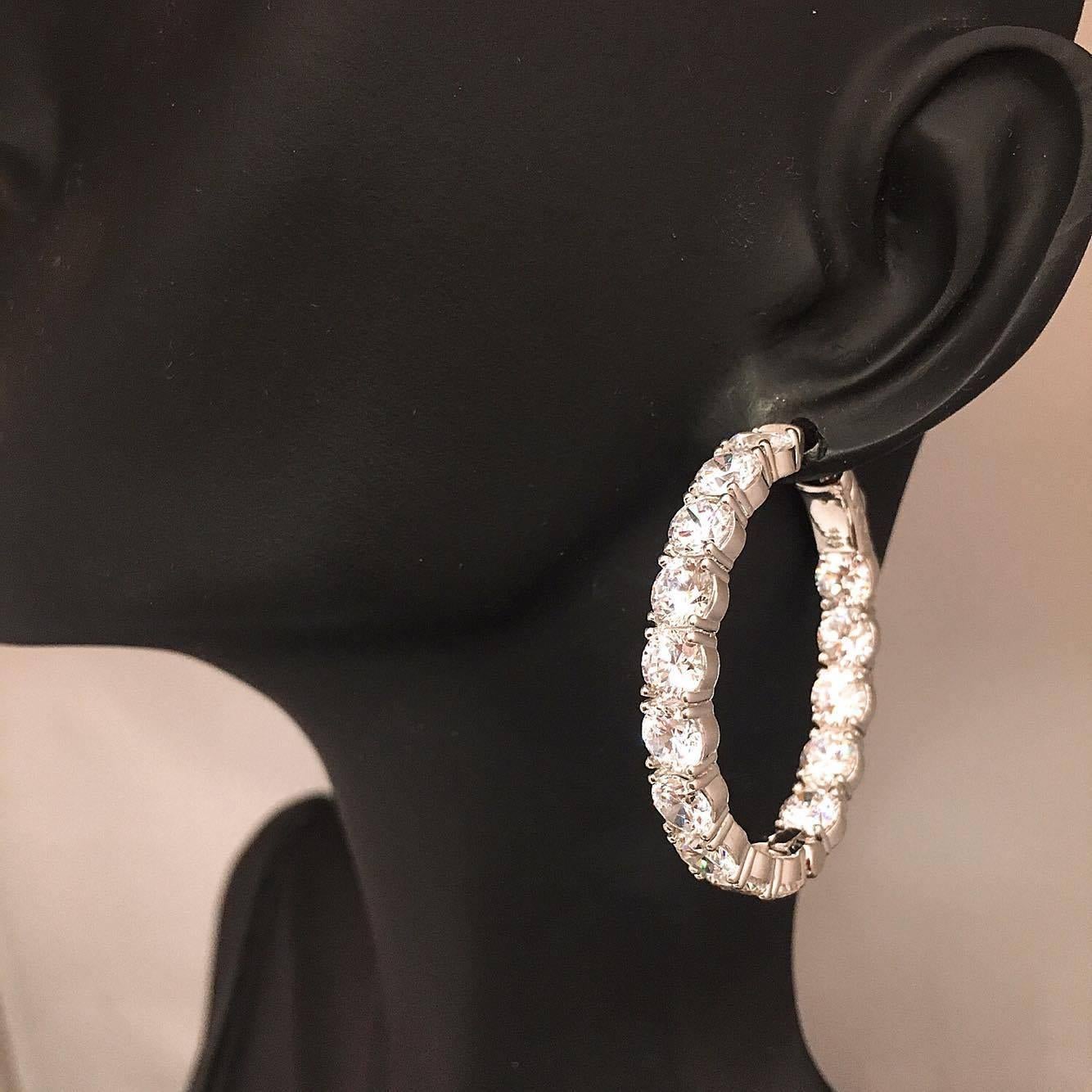 Our one of a kind push locking mechanism ensures this hoop never falls off your ear! The measurement of these hoops is approximately 1.25 inch top to bottom measurement.
Approx Total weight: 11.20 Carats 
Color: F 
Clarity: Vs 
Cut: Excellent 

If