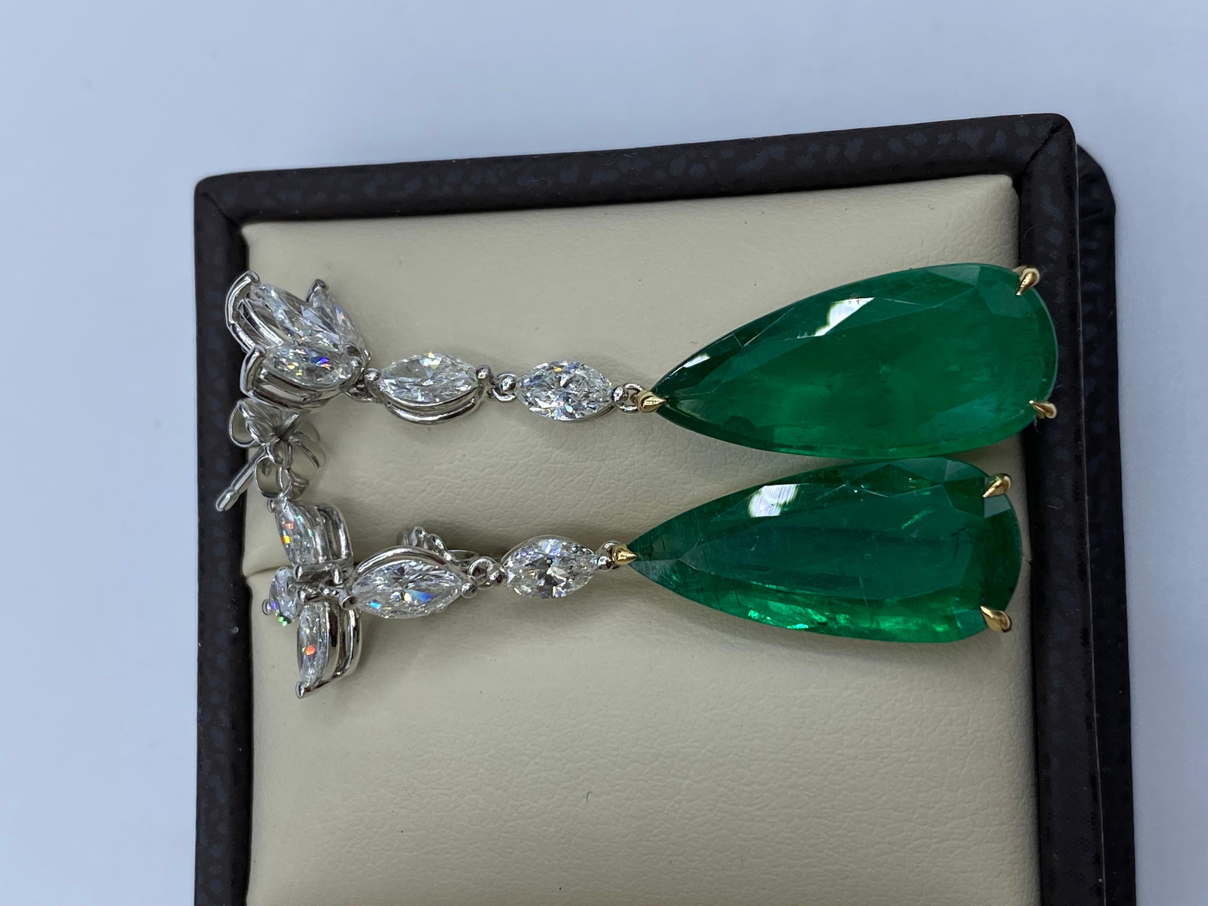 From Emilio Jewelry, a well known and respected wholesaler/dealer located on New York’s iconic Fifth Avenue, 
2 gorgeous teardrop emeralds totaling 12.98 carats, are the focal point of this earring. The emeralds are not heavy at all, and give a