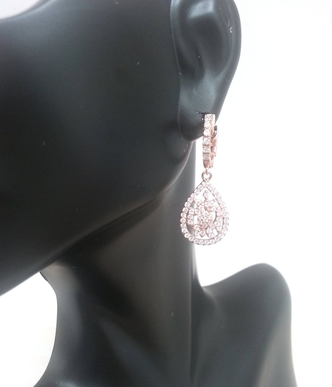 These earrings were set in 14k rose gold (also available in all other gold colors or 18k) set with 22 colorless round diamonds VS clarity. The earrings feature a unique push lock which needs to be pressed down to open the huggie.