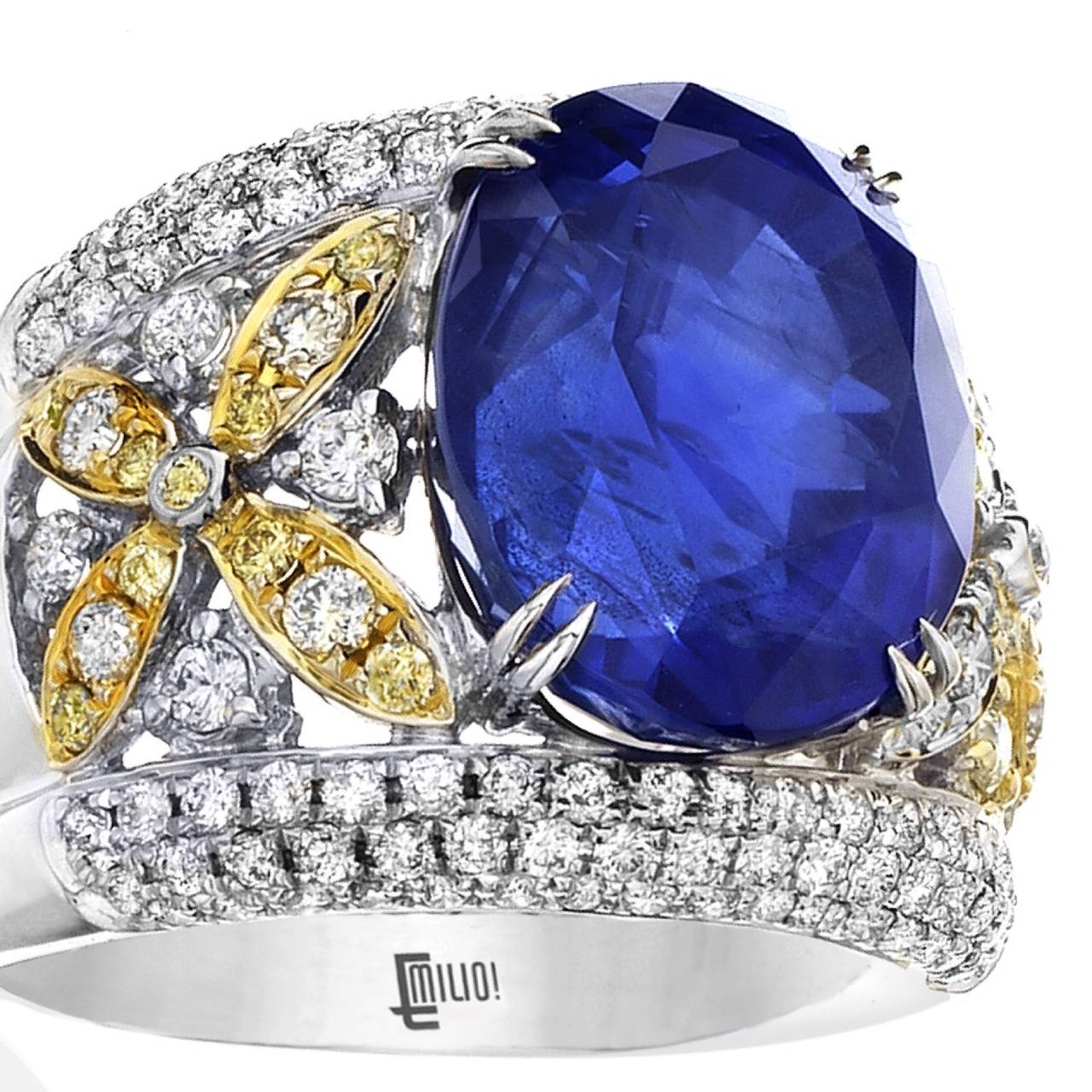 This magnificent ring is truly one of a kind. An oval deep blue natural Ceylon Sapphire sits in the center of this 18k gold ring micro pave diamonds overflowing along the sides. There are visible inclusions however the stones color over powers them