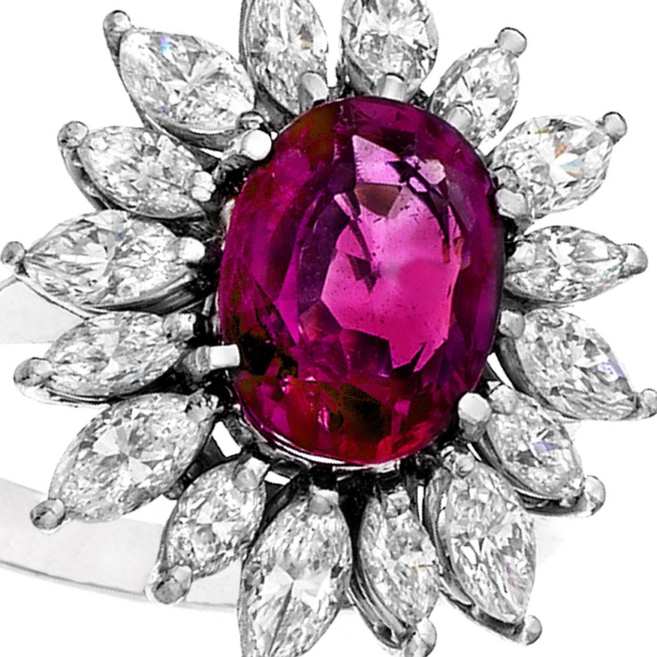 A 2.75 carat Burma Ruby sits in the center of this ring. Unheated natural Burma rubies are extremely rare, especially in this color. The center Ruby is surrounded with marquise shaped diamonds. 

Ruby: 2.75ct
Diamonds: approximately 2.00ct