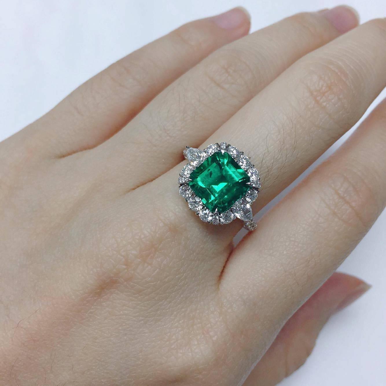 Ring in 18kt white gold set with one octagonal cut Colombian Emerald intense green (2.81 carat), 2 pear-shaped diamonds (0.37 carats), and 144 brilliant-cut diamonds (1.39 carats) E Color VVS clarity excellent cuts. 